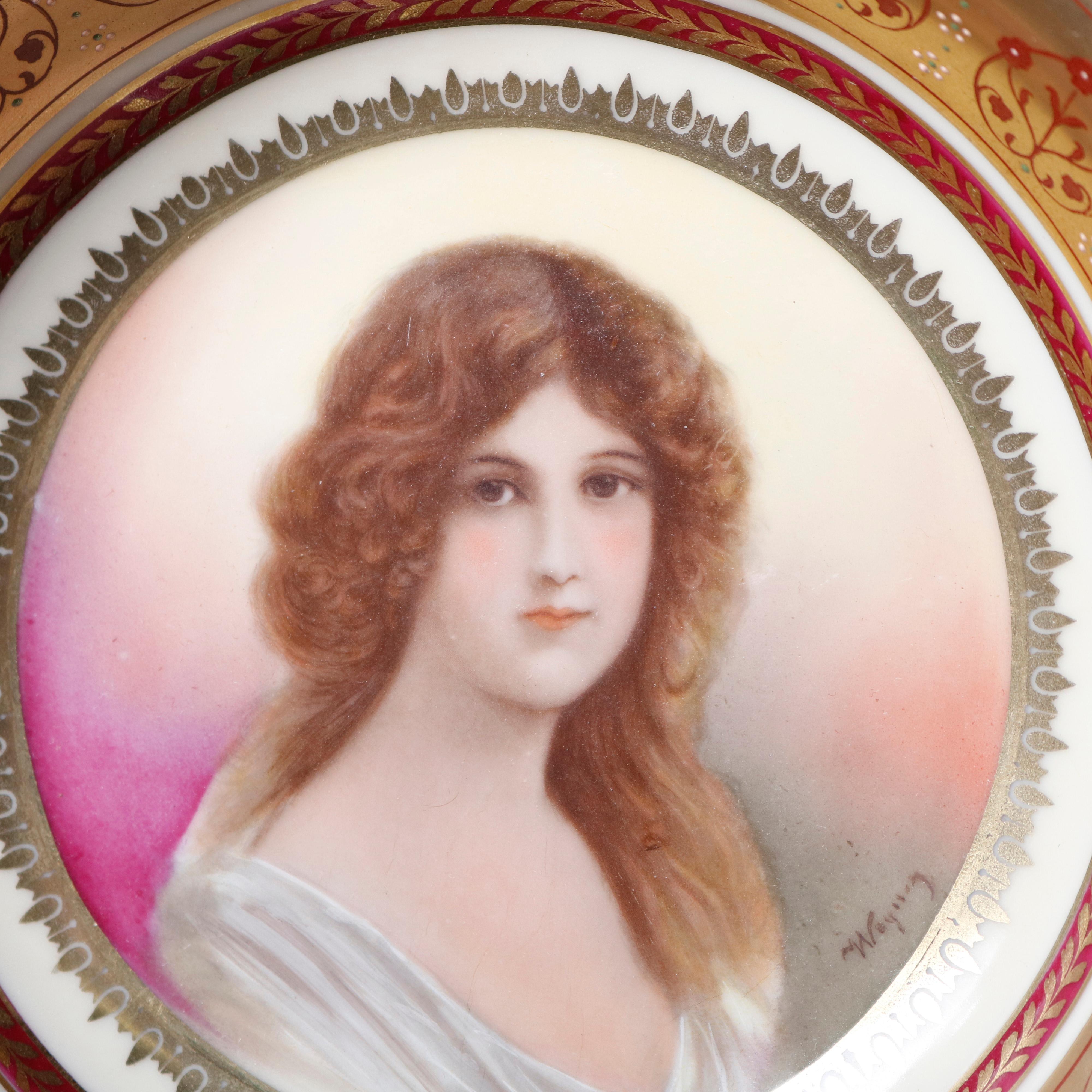 An antique Austrian Royal Vienna style porcelain bowl offers hand painted portrait of maiden, artist signed Wagner, rim with foliate decoration and laurel wreath reserves, gilt highlights throughout, en verso signed as photographed, circa