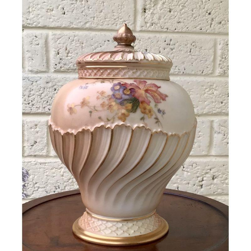 Royal Worcester Blush Ivory Pot Pourri And Cover, 

Decorated with floral sprays above the spiral moulded base, with lattice moulded border, with inner cover and pierced main cover, transfer mark in puce, 
Dated 1906
Shape number 1720,
21cm