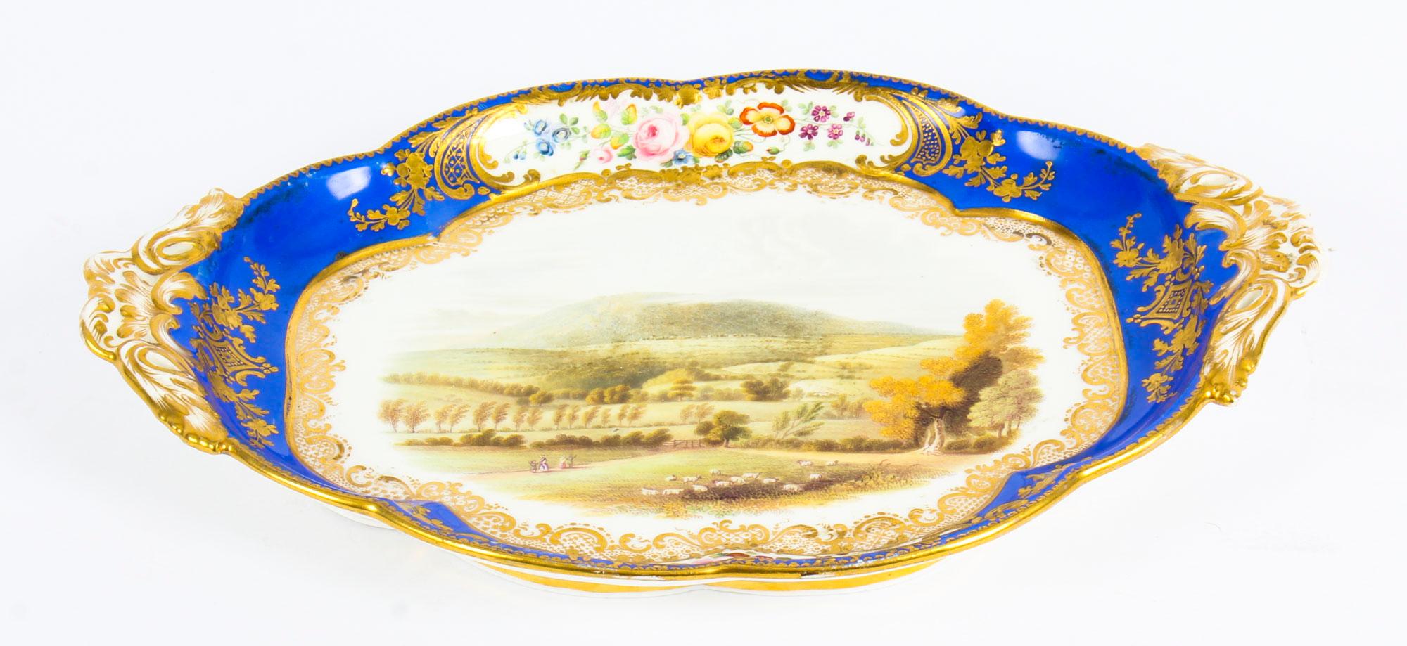 This is a fine and unique antique Royal Worcester porcelain landscape dish, circa 1840 in date.
 
The Worcester Royal blue oval shaped dish is beautifully painted with a view of The Wrekin in Shropshire in the centre and framed with a royal blue