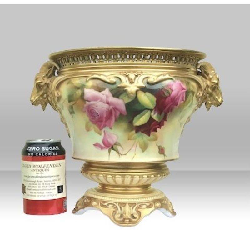 Fabulous large antique Royal Worcester rose floral decorated and gilt jardiniere, , with horned mask handles, painted with full blown roses, signed and printed mark in puce. 

Pattern 168/H1574, 
24cm x 22.5cm x 29cm wide 
Dated 1891