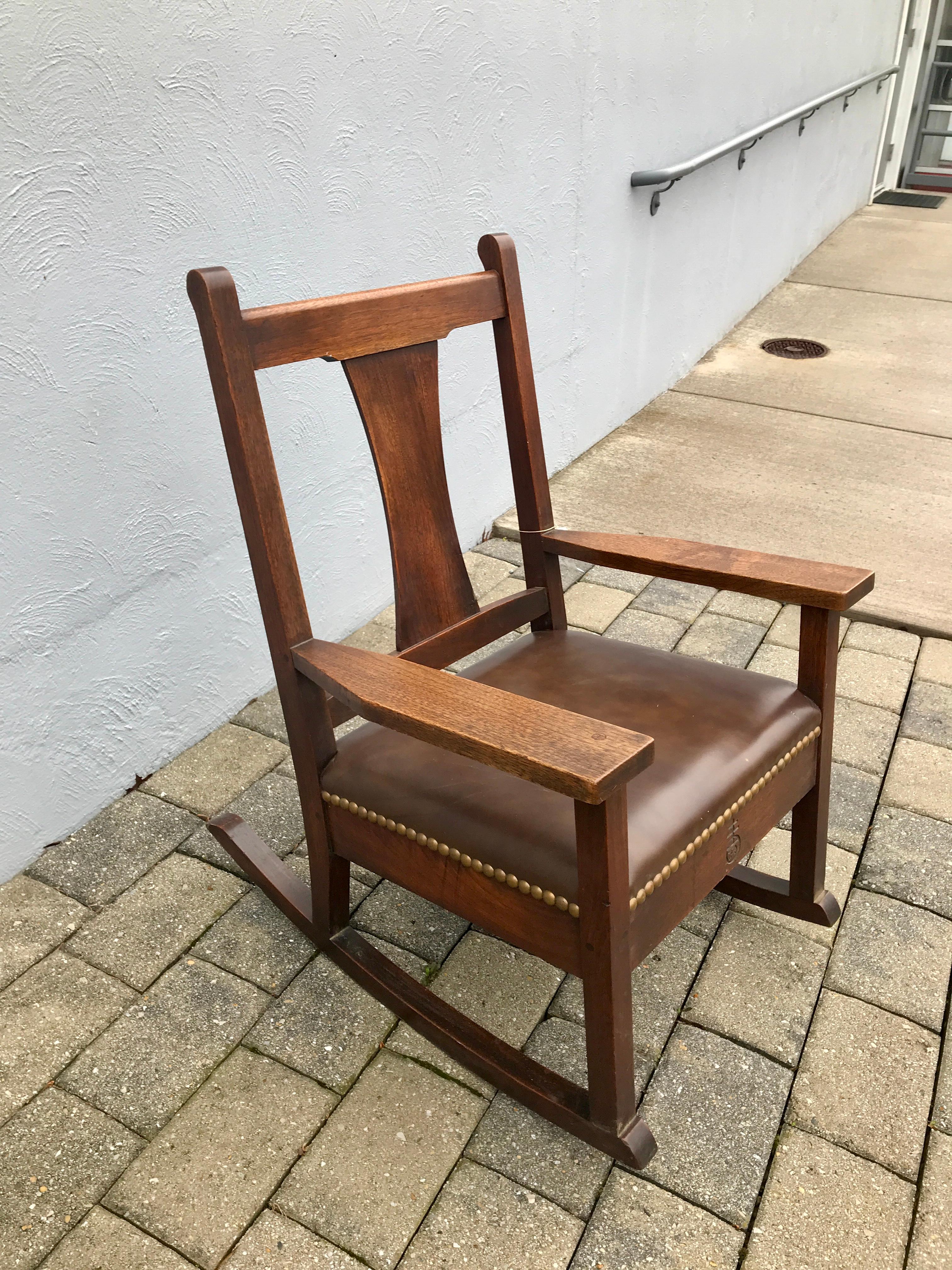 This is an antique Roycroft T-Back Rocking Chair from the early 1900s.  It is in excellent condition with no repairs or replaced parts.  STURDY & STRONG, this rocking chair is ready for use in your home or office.
We have over 400 chairs in our