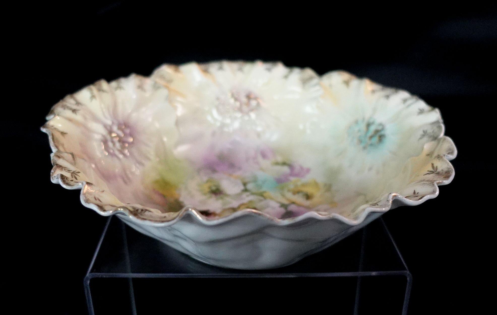 A wonderful RS Prussia German porcelain bowl in lovely multi-colors, the center of the bowl has beautiful many flowers presented in different colors, a very adorable artwork.
   
