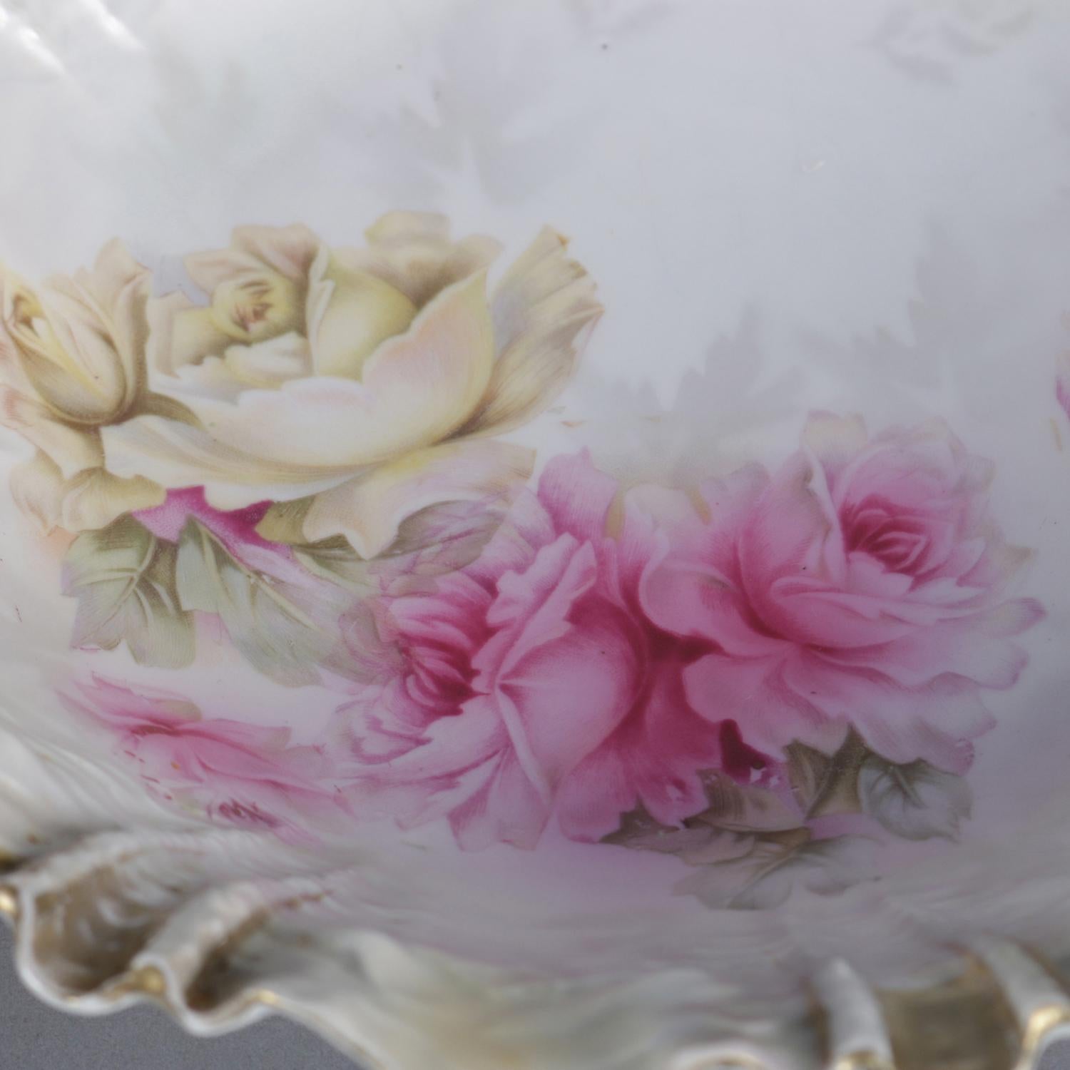 Antique R.S. Prussia porcelain center bowl features ruffled rim and has hand painted floral rose design with gilt highlights and pearled finish, en verso RS Prussia wreath stamp, circa 1900


Measures : 2.75