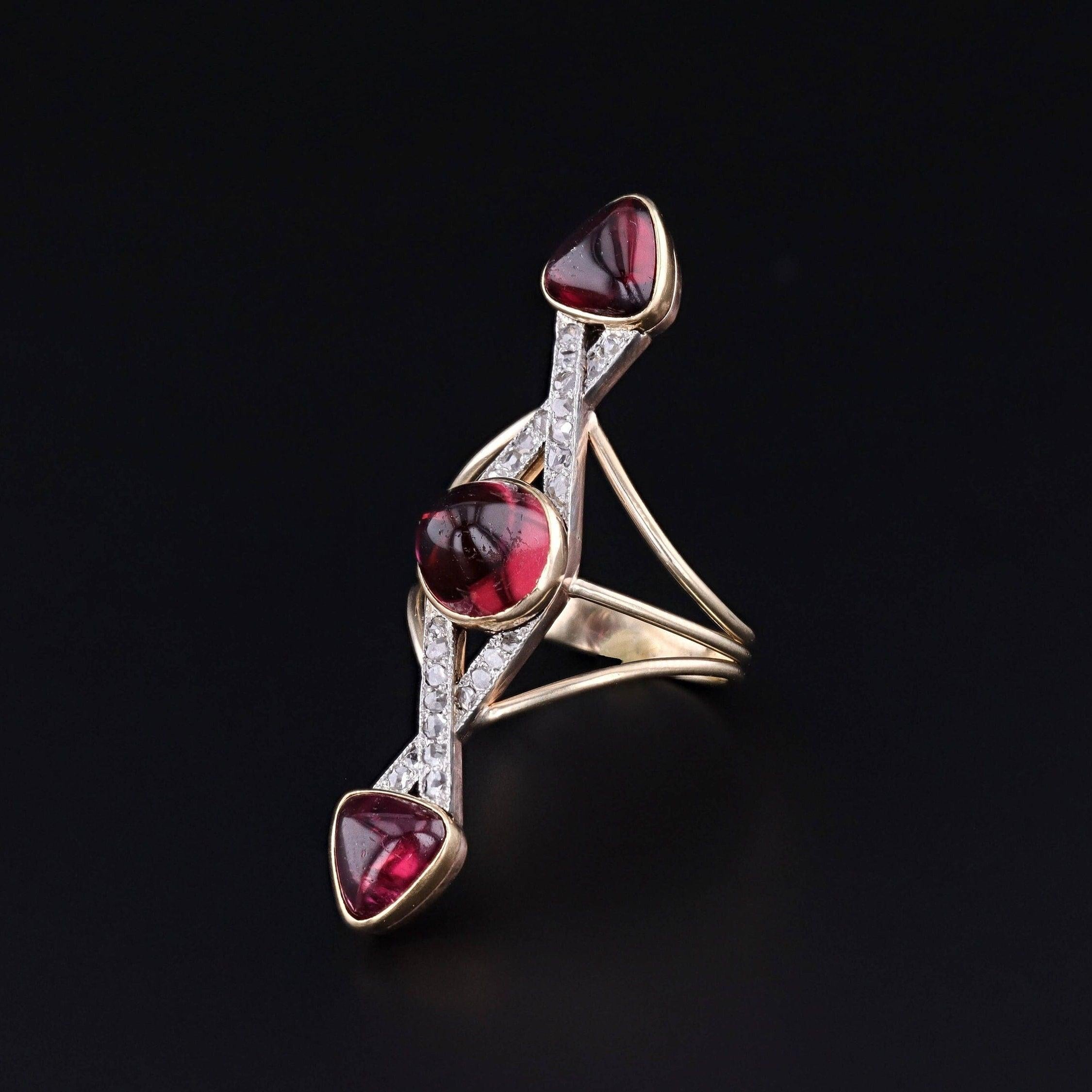 An elongated ring created from an antique bar pin (circa 1910-1920).

The face of the ring is platinum topped 14k gold and accented with rubellite (tourmaline) and rose cut diamonds. The custom made mounting is 14k gold. 

The face of the ring