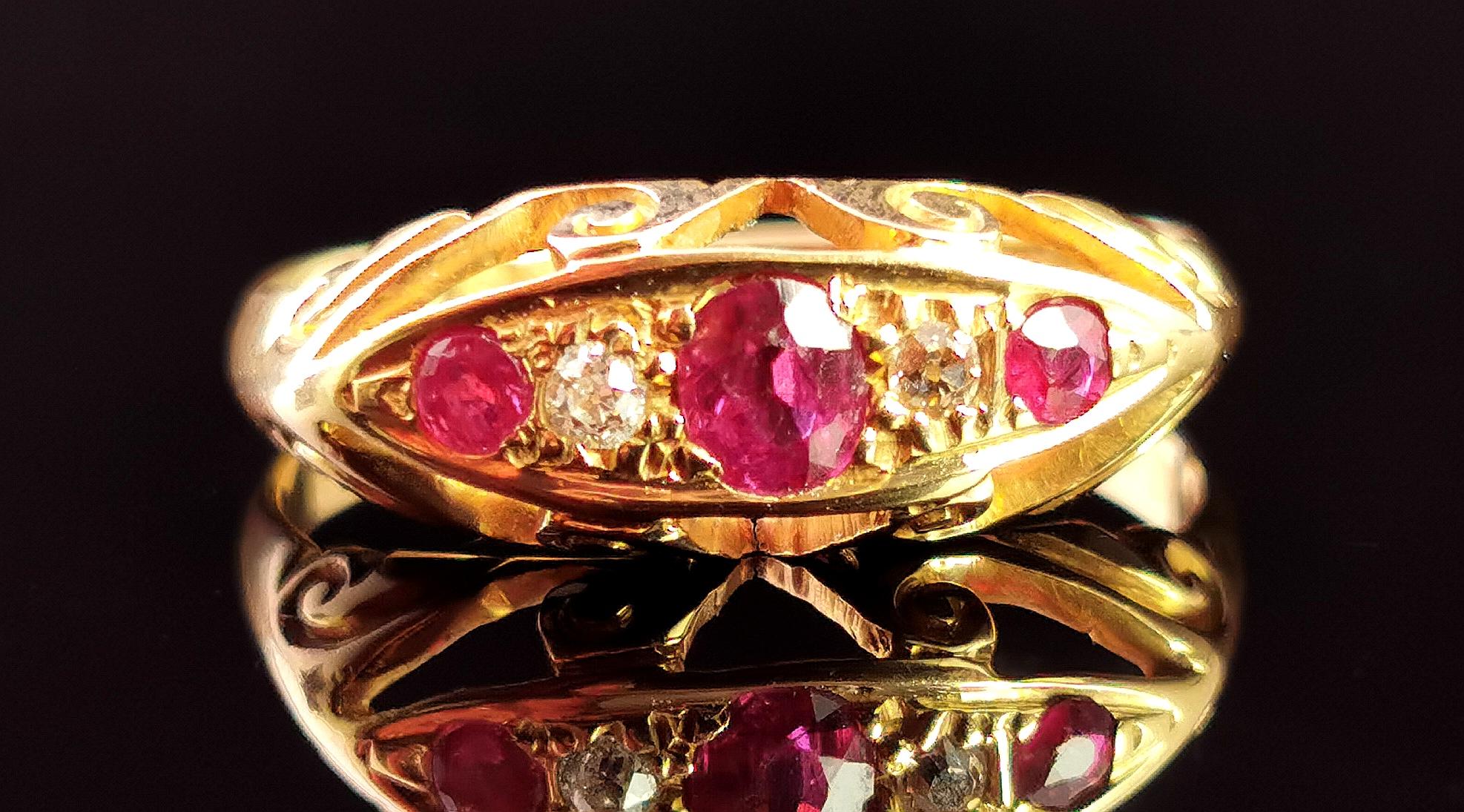A beautiful antique, early Art Deco era Ruby and Diamond ring in 18kt yellow gold.

This beautiful ring is a boat head style ring with a gemstone set face and lovely scroll work to the shoulders, reminiscent of the Victorian era in its design.

It