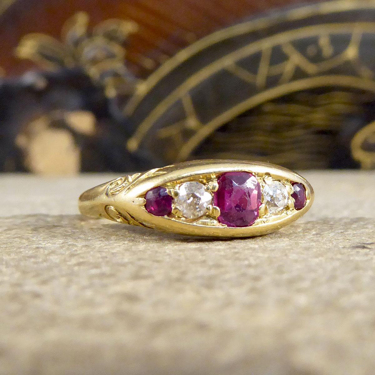 This striking Late Victorian to Early Edwardian ring features an east-west oriented navette-shaped face set with gorgeous Ruby in the centre and either end with two Diamonds between the Sapphires. This boat ring has been crafted from 18ct Yellow