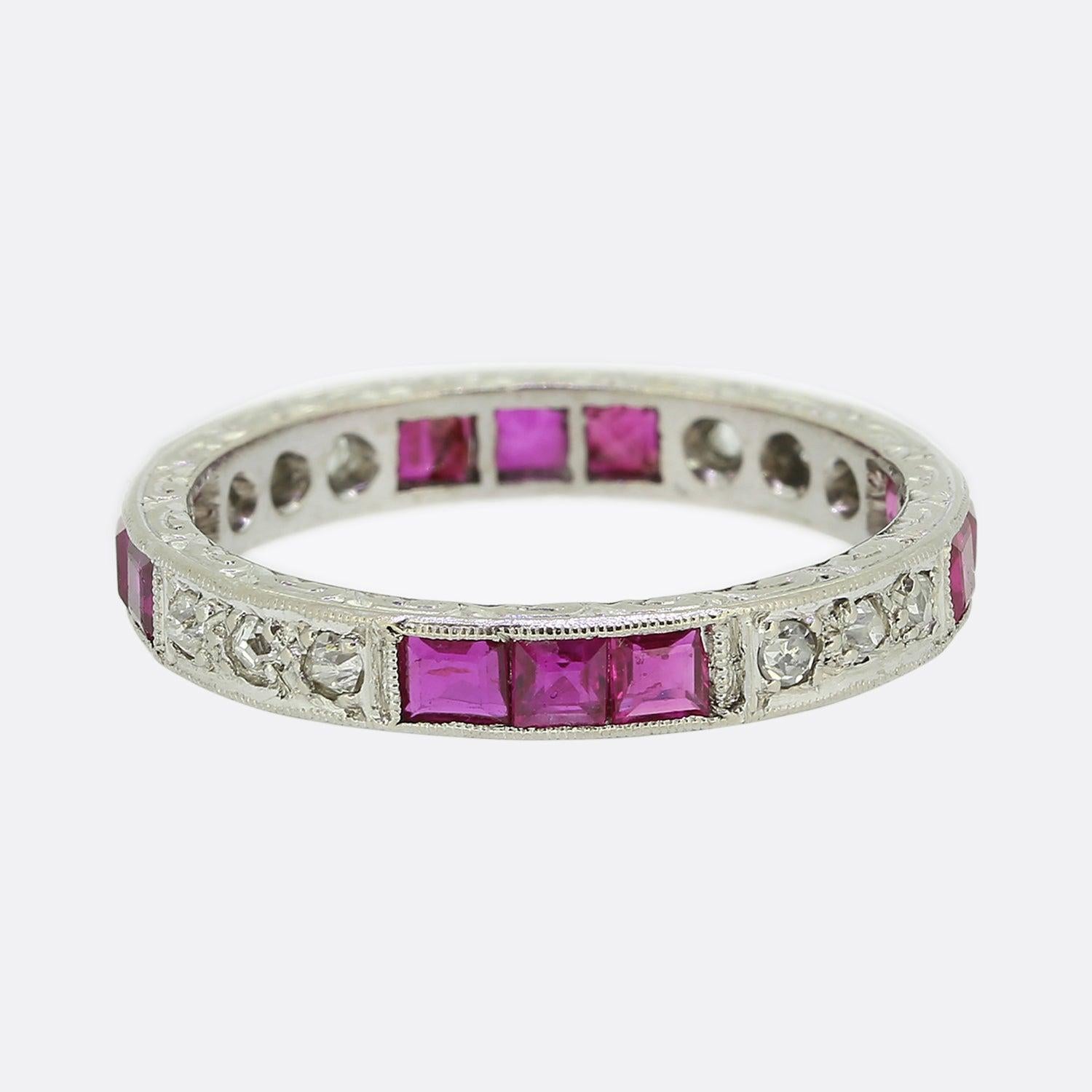 Here we have an elegant antique ruby and diamond full eternity ring. The band here has been crafted from platinum and plays host to alternating trios of square calibrated pink rubies and round faceted white old cut diamonds. A fine milgrain