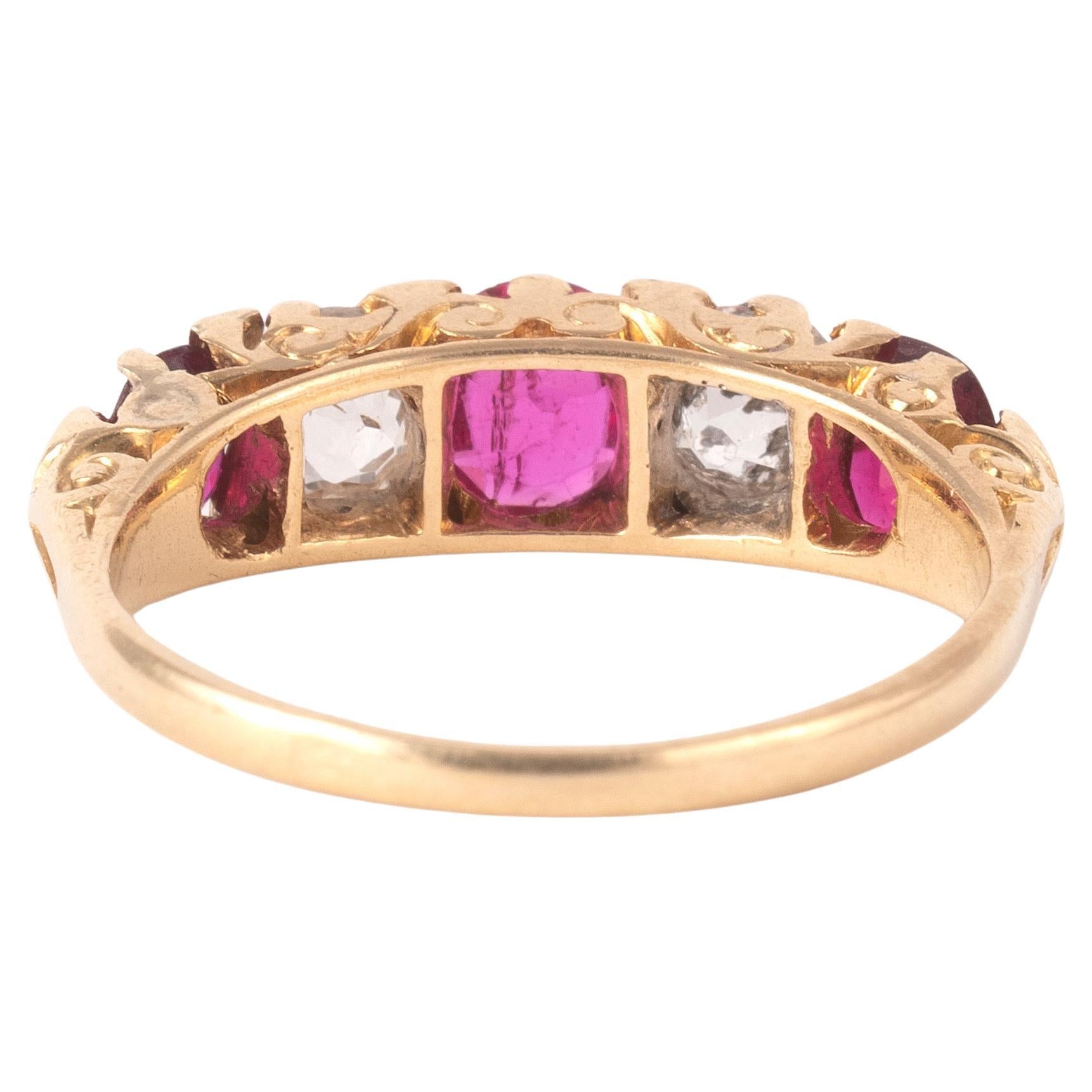 lternating cushion cut rubies and old-cut diamonds, claw setting, between scrolled shoulders, mounted in gold, total ruby weight approxiamtely 0.90cts, total diamond weight approximately 1ct
Ring size 7
Weight: 3,4gr.

Accompanied by a certificate