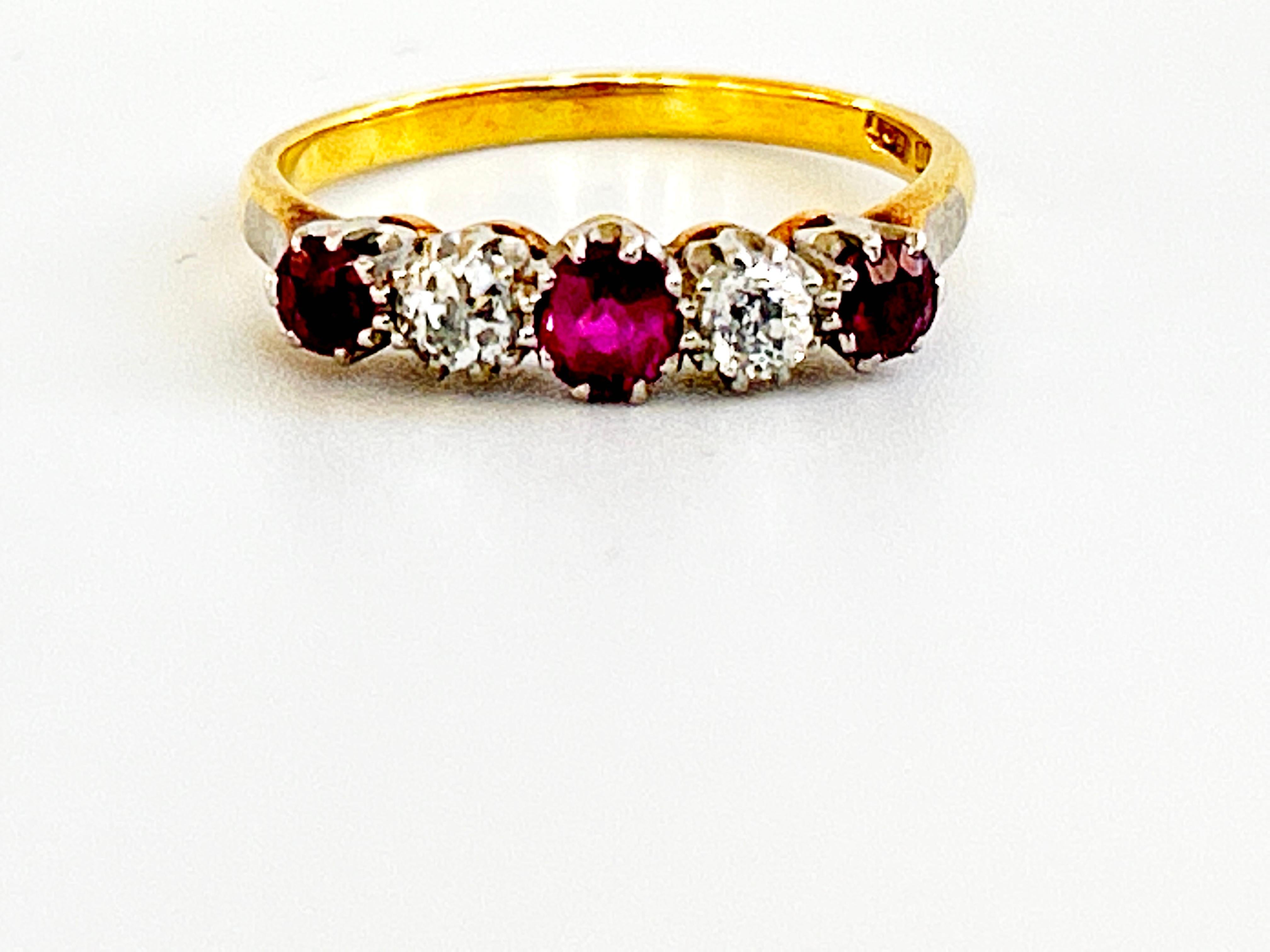 A Ruby and Diamond half hoop ring, three round faceted rubies and two old cut diamonds claw set in a yellow and white gold mount ring.shank marked 18ct. Plat, gross weight 3.4g.
Diamonds: Color is G-I, Clarity I -I2
Measurements: Center Ruby 4.02mm