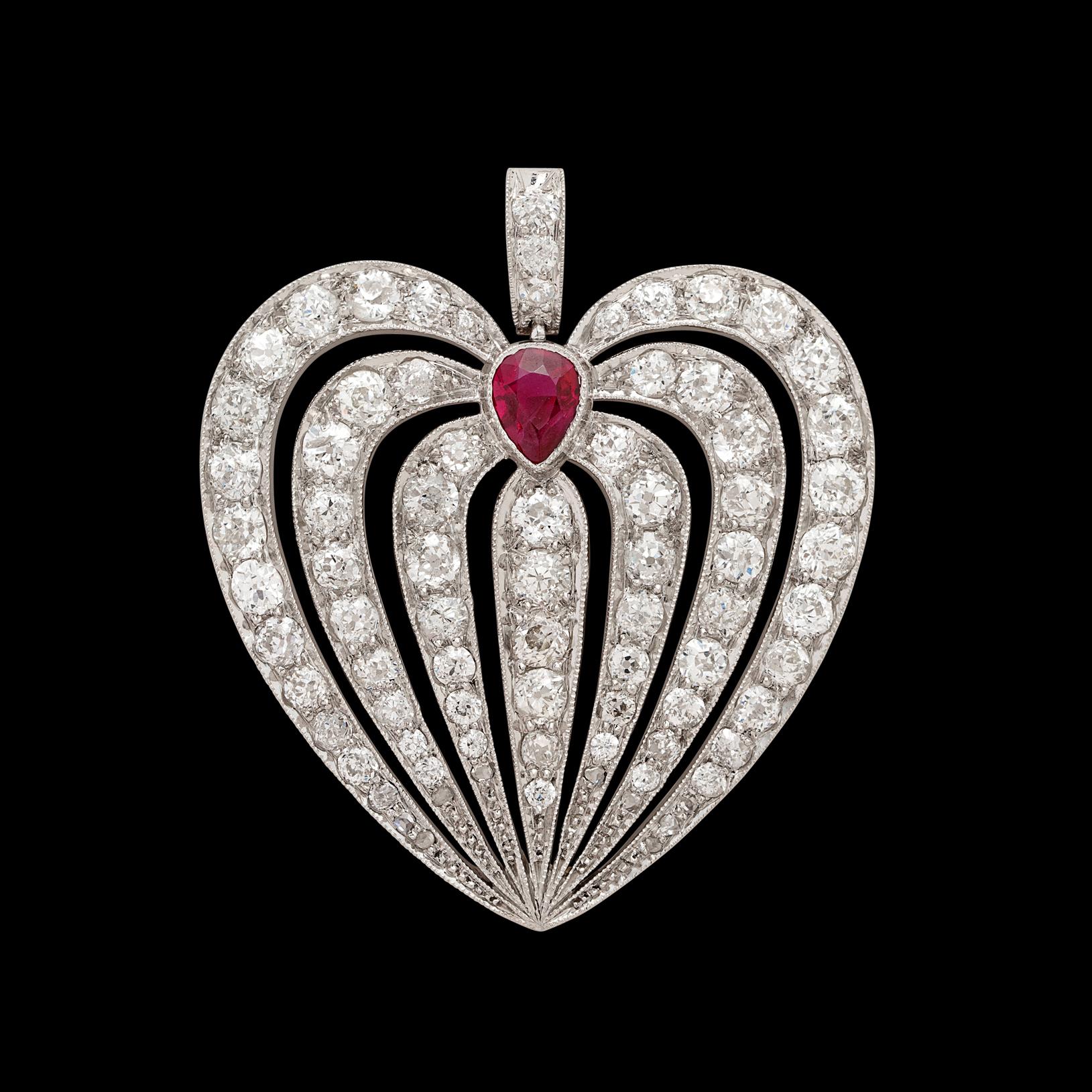 Featuring the type of craftsmanship one can only find in an era long gone by, this antique pendant features 79 Old Mine Cut Diamonds for a total weight of 4.75 carats, all surrounding one exceptional pigeon's blood red ruby. The pear shaped ruby,