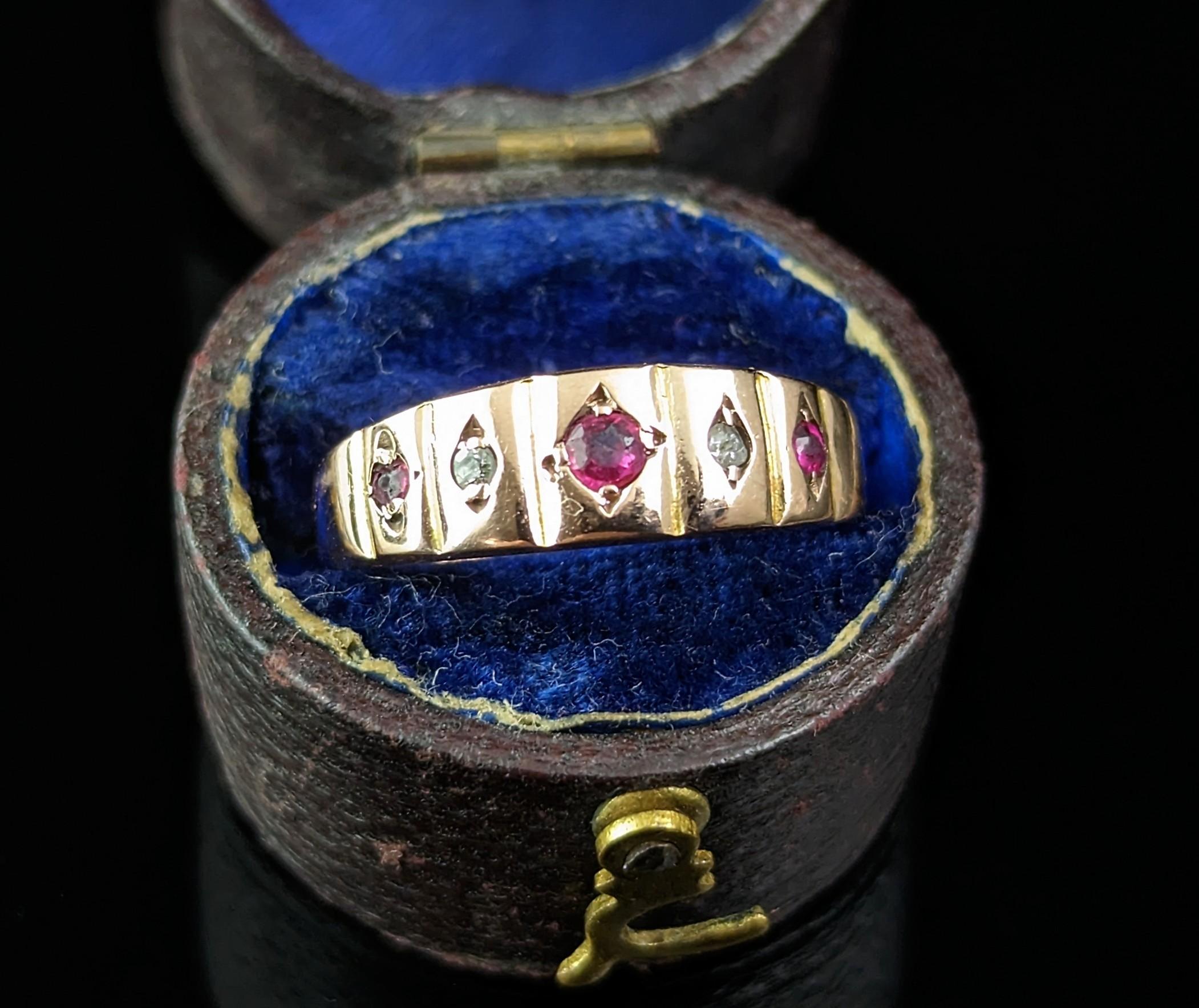 A gorgeous antique early Art Deco era Ruby and Diamond ring.

It is a band style ring with five stones, three rich Pinky coloured rubies and two rose cut diamonds, set into diamond shaped settings across the front of the band.

The gold has a lovely