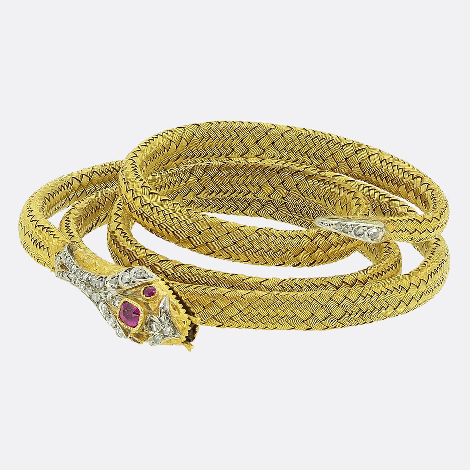 Here we have a excellently crafted gem set snake bracelet from the Victorian era. Crafted in a rich 18ct yellow gold, this antique piece coils around the wearer’s wrist and features a flexible body with a secure steel spring inside. Between an