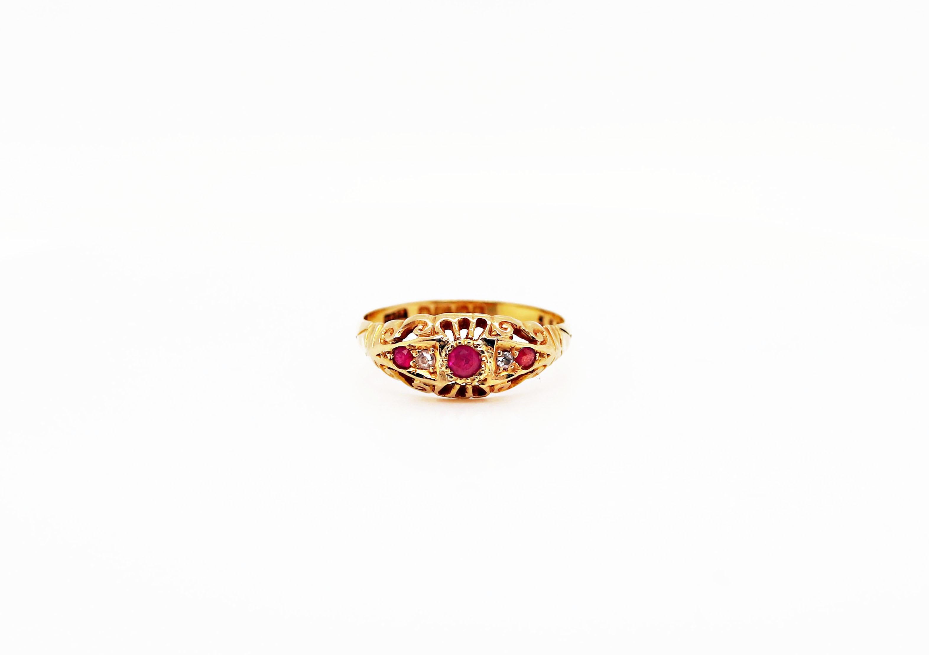This beautiful ring features 3 round rubies accompanied by two old cut diamonds all mounted in a classic original 18 carat yellow gold setting. English hallmarks - 1918. UK finger size 'Q'.