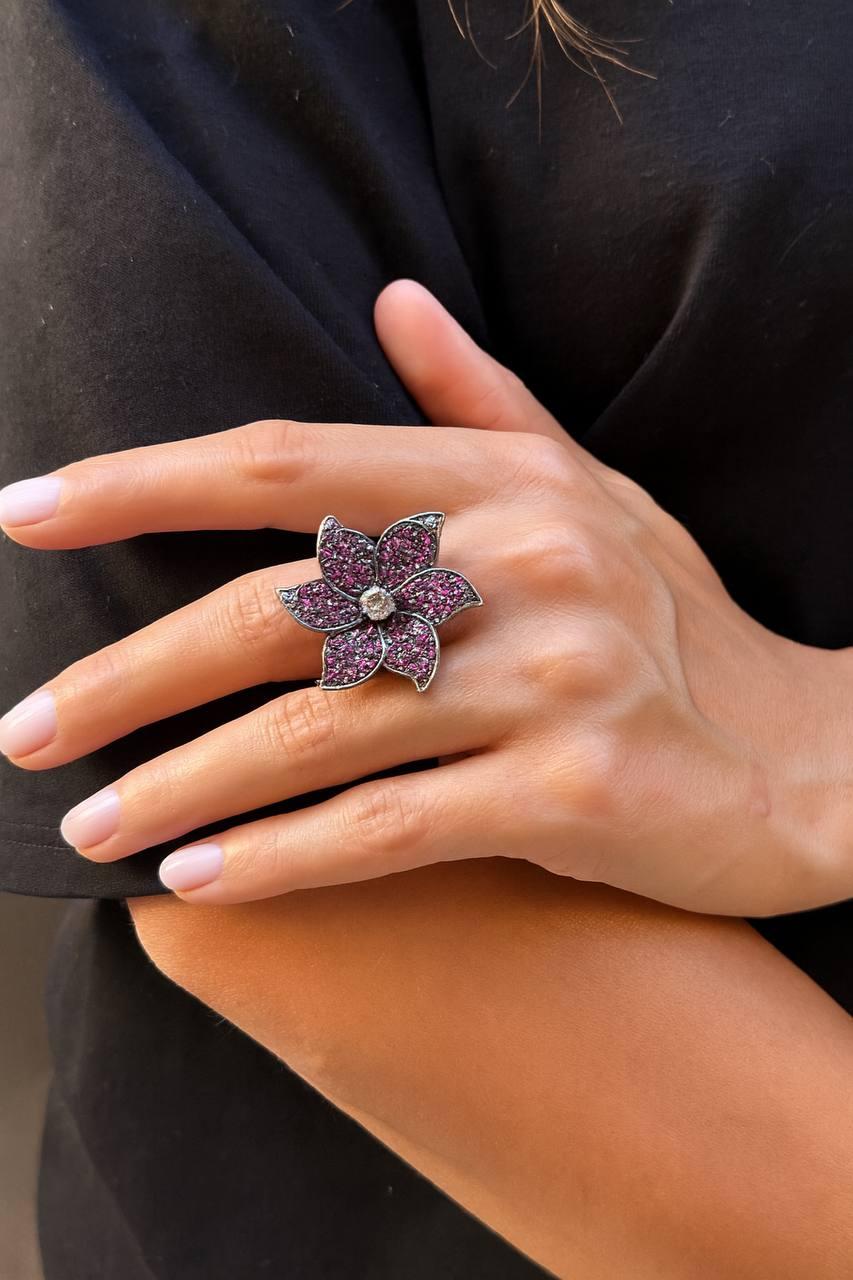 An old Unique ring in the shape of a flower, made of Gold and Silver , covered on top by Ruby ( Thailand ) and central old-cut diamond of the weight 0.90 carats .