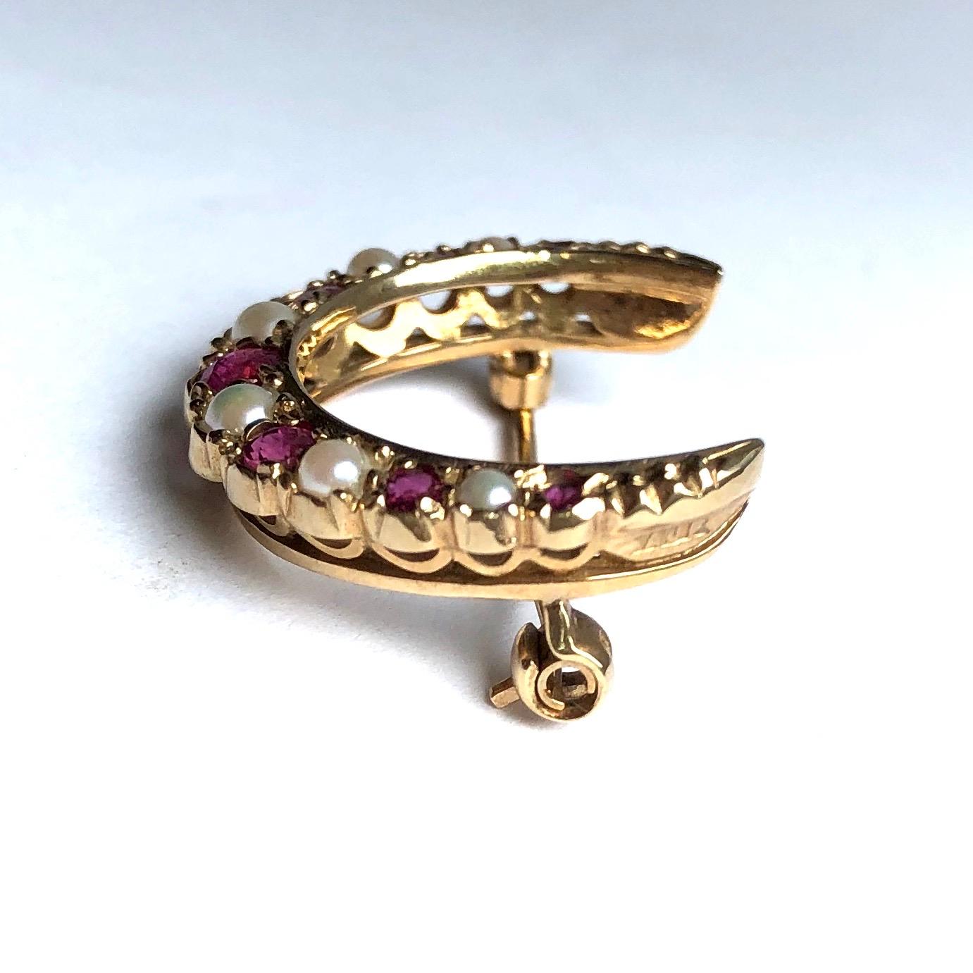 This fabulous crescent brooch has seven rubies and six pearls set within the 9ct gold. The rubies total approx 60pts. I always like to mention that crescent brooches can be hooked onto a chain to make a gorgeous pendant. 

Crescent dimensions: