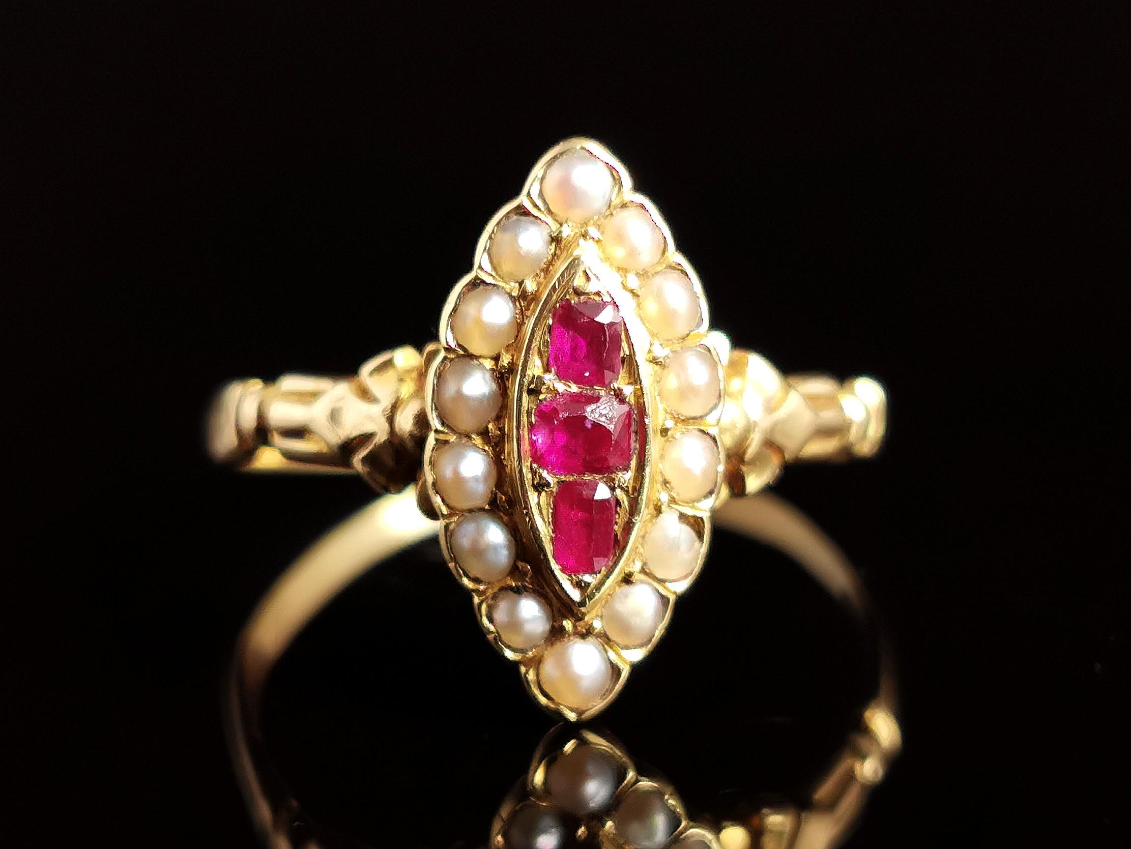 A pretty antique, Victorian era Ruby and seed pearl navette ring in 18kt yellow gold.

Three beautiful pinky red rubies set to the centre, each a slightly different size and shape all old cushion cut, surrounded by a halo of creamy seed pearl.

The