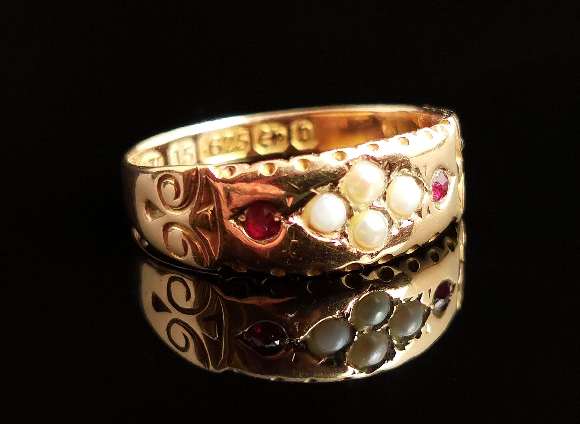 A pretty antique, Victorian era 15kt gold and pearl ring.

It is nicely designed and is a fancy take on the band ring with a wider front, gem set with two rubies and a four seed pearl centre.

The pearls are arranged in a diamond shape and one