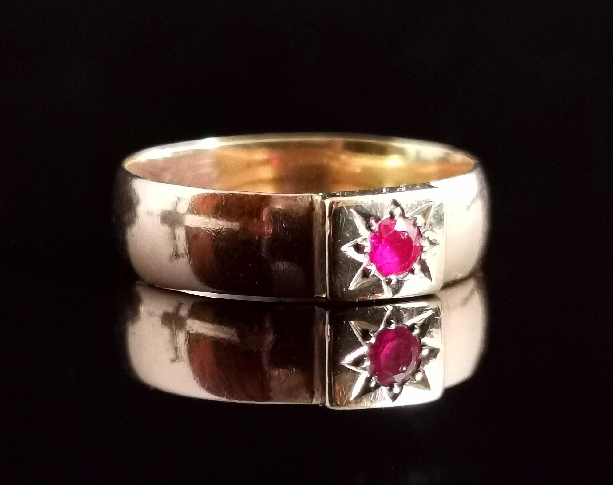 A beautiful antique early Art Deco era chunky 9 karat yellow gold band ring.

The ring has a nice wide old gold band with a light D profile, the face has a raised square panel gypsy or star set with a vibrant pinky synthetic Ruby.

A gorgeous