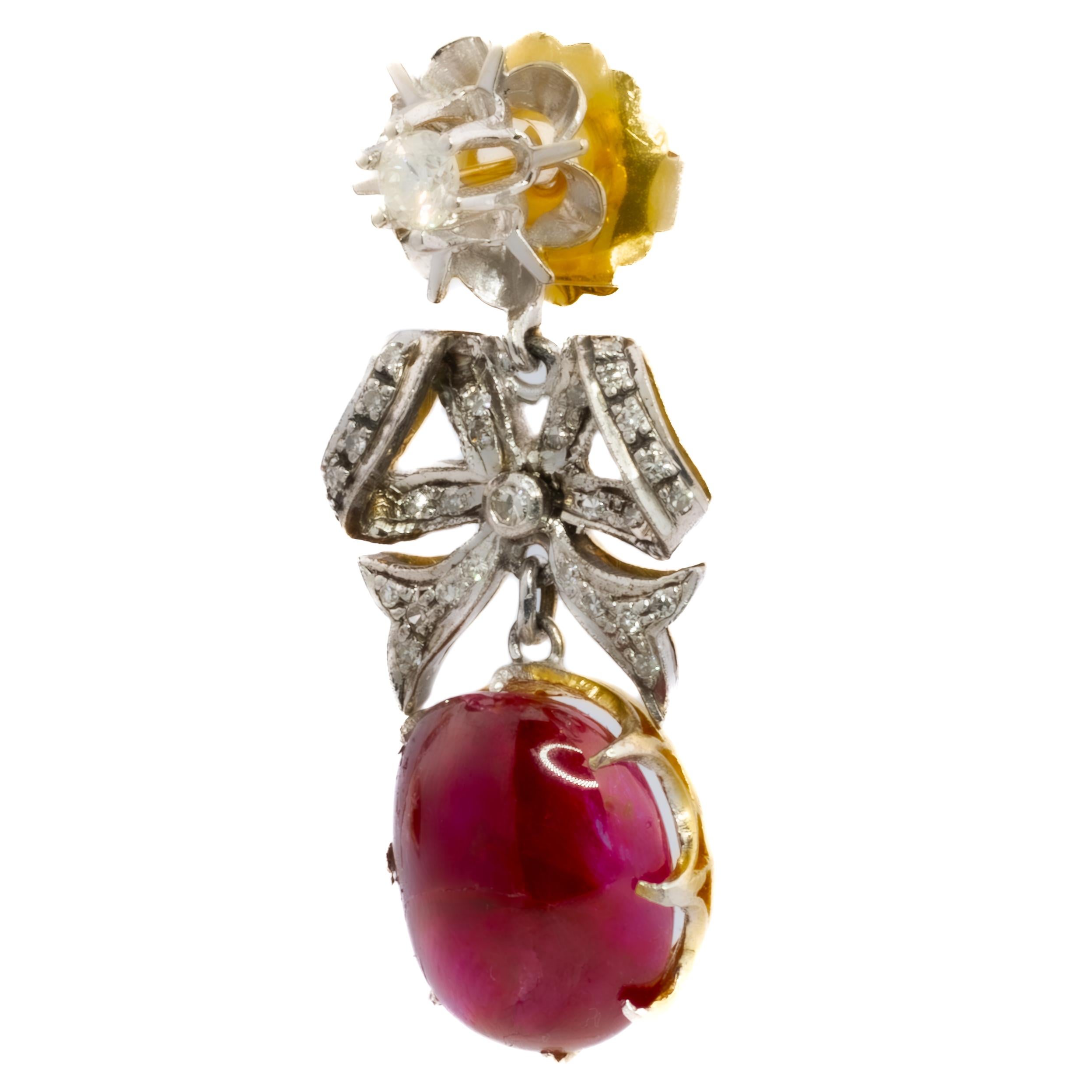Antique Ruby Cabochon and Diamond Bow Drop Earrings

Description:
Charming and timeless, these antique drop earrings feature two striking ruby cabochons weighing approximately 22.45 carats in total, each suspended beneath a delicate diamond-set bow.