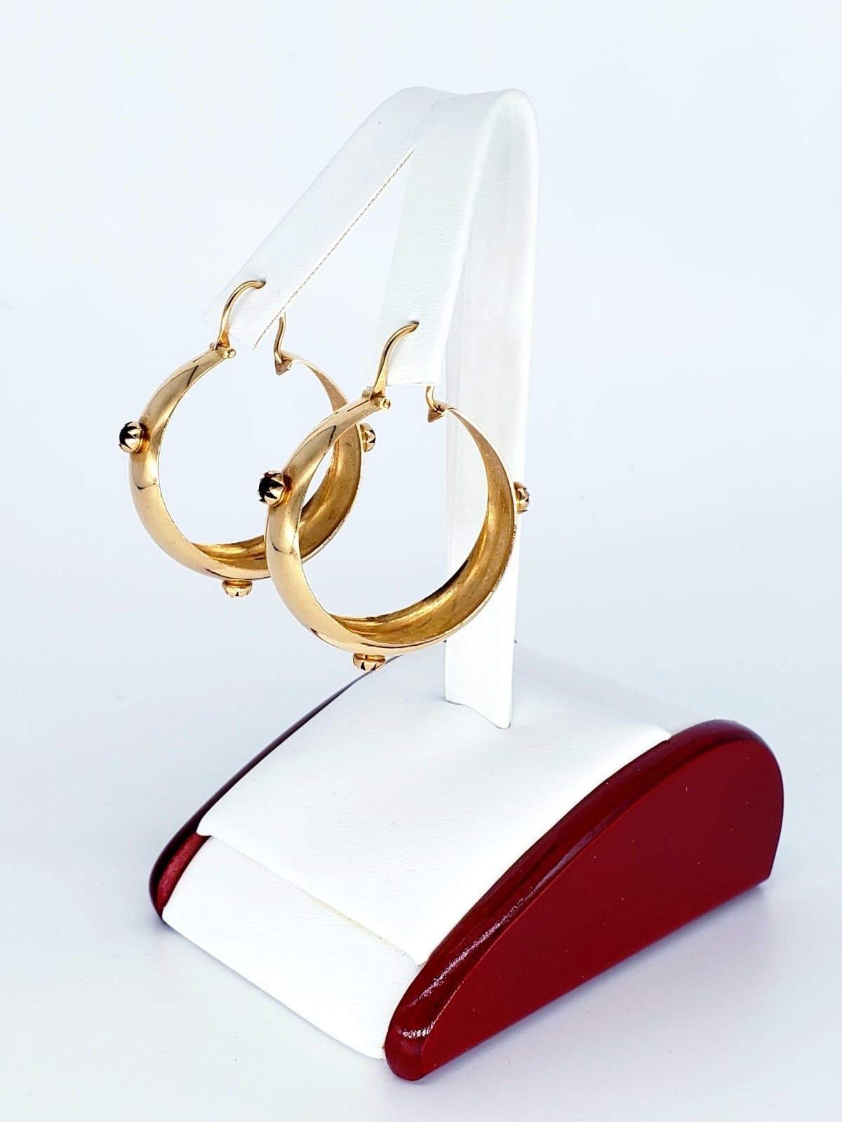 Antique Ruby Cabochon Hoop Earrings 18k Gold. These are a very unique and rare pair of Ruby Cabochon earrings. The earrings measure 1” height & 10.8mm wide. Each Ruby measures 4mm and stamped 18k 750 for gold purity. The earrings weight 9.4 grams.