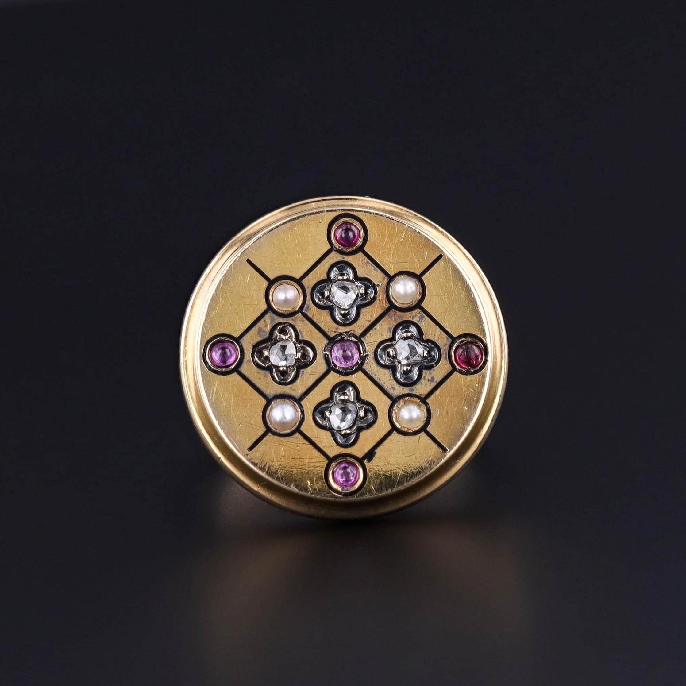 Antique Ring: This ring features rubies, diamonds, and pearls set in an 18k gold medallion. It was originally an antique button (circa 1860) transformed with the addition of a 10k gold band.

The face of the ring measures 0.8 inches in diameter and