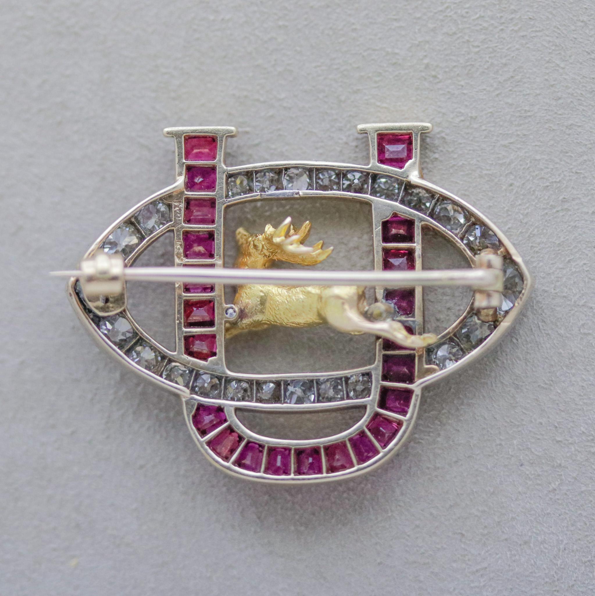 A stunning antique from the late 19th century featuring old European-cut diamonds and vivid red Burmese rubies! The rubies are set in a U shape while the diamonds are set in the opposite direction. In its center is a proud and strong gold stag, a