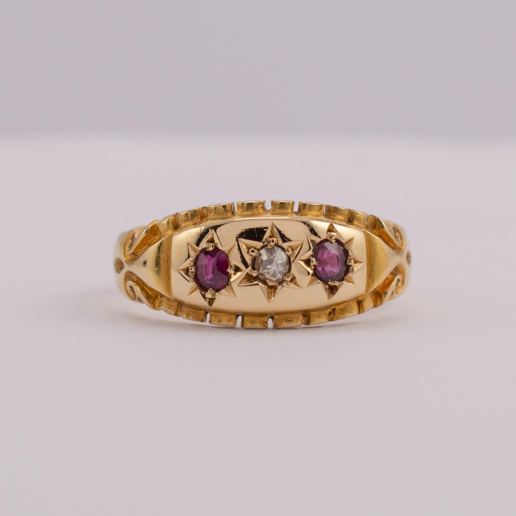 A fine quality antique ruby and diamond gypsy ring crafted in 18k yellow gold, dated Chester 1900.

The ring displays two rubies with center old European cut diamond. The gemstones are set into stars on the smooth rounded head with fluted lower lip.
