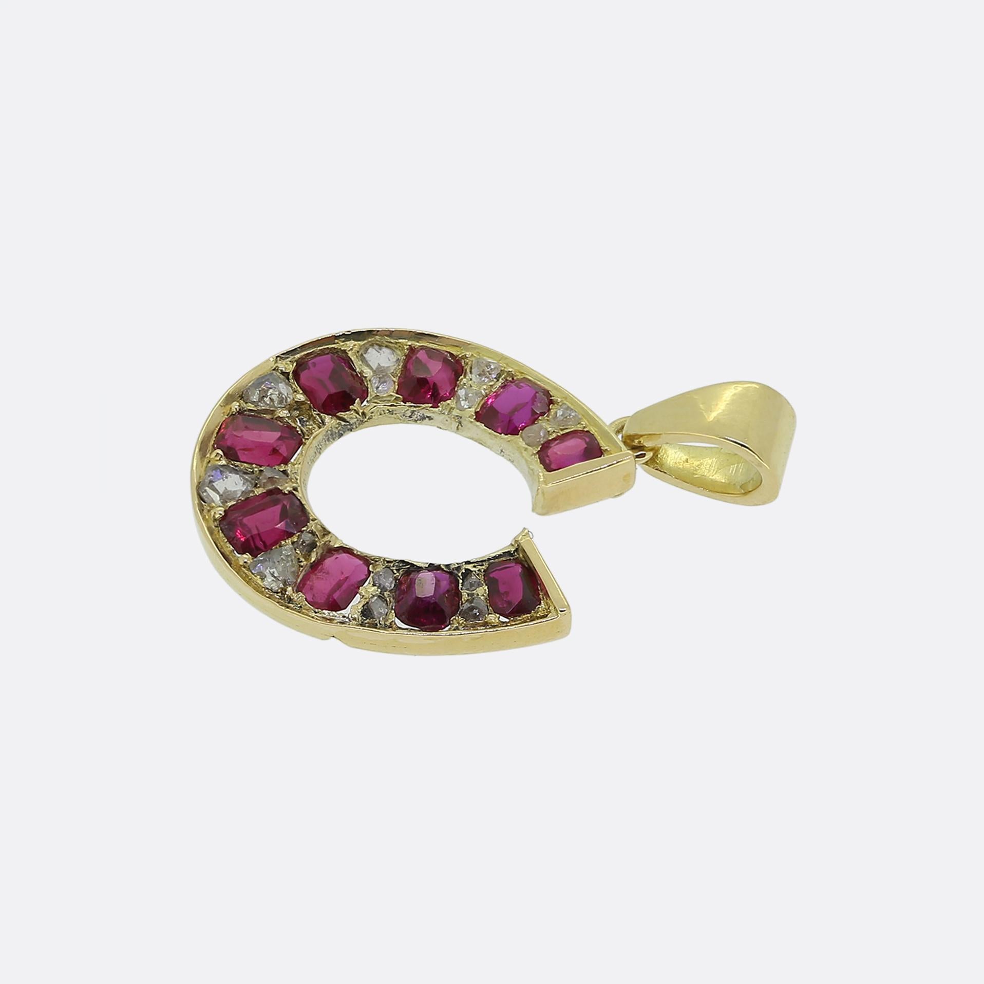 This is a wonderful 18ct yellow gold ruby and diamond horseshoe pendant. The pendant features nine natural rubies that are separated by rose cut diamonds. The bale is more modern and the horseshoe was most likely converted from Victorian brooch. It