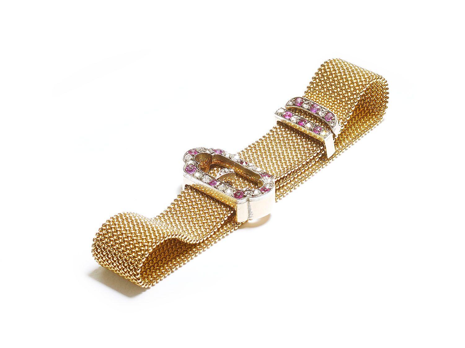 A late 19th century, gold mesh mail buckle bracelet, set with Burma rubies and rose-cut diamonds, in a silver set sliding buckle, sliding loop and terminal, on gold mesh mail. English, circa 1890. The buckle is approximately 26.9 x 14mm. The length
