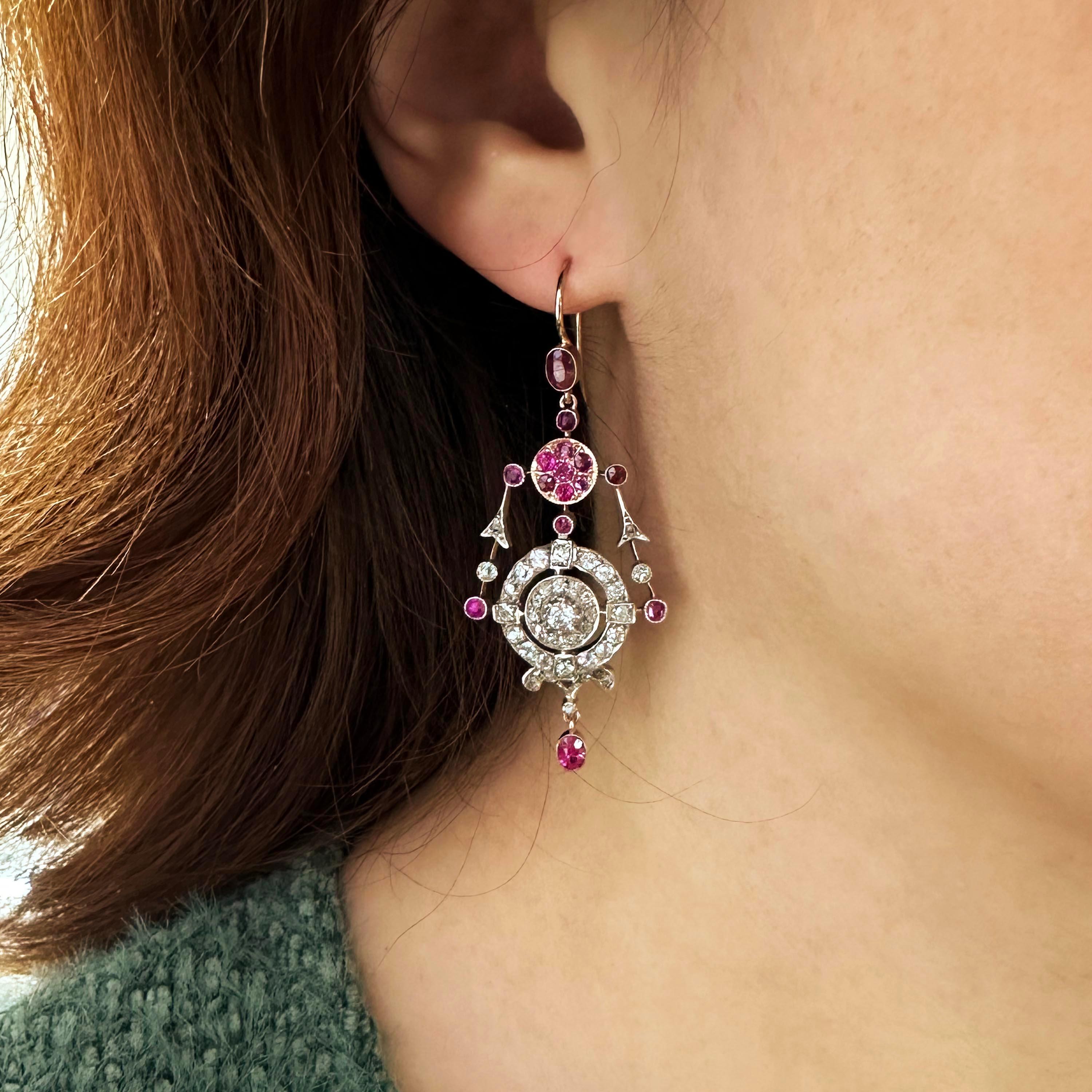 A pair of ruby, diamond and gold drop, earrings, with cushion-cut ruby set tops, above a cluster of rubies and, with a ring of old mine-cut and rose-cut diamonds below, with a cluster in the centre, with garlands either side and a ruby pendant,