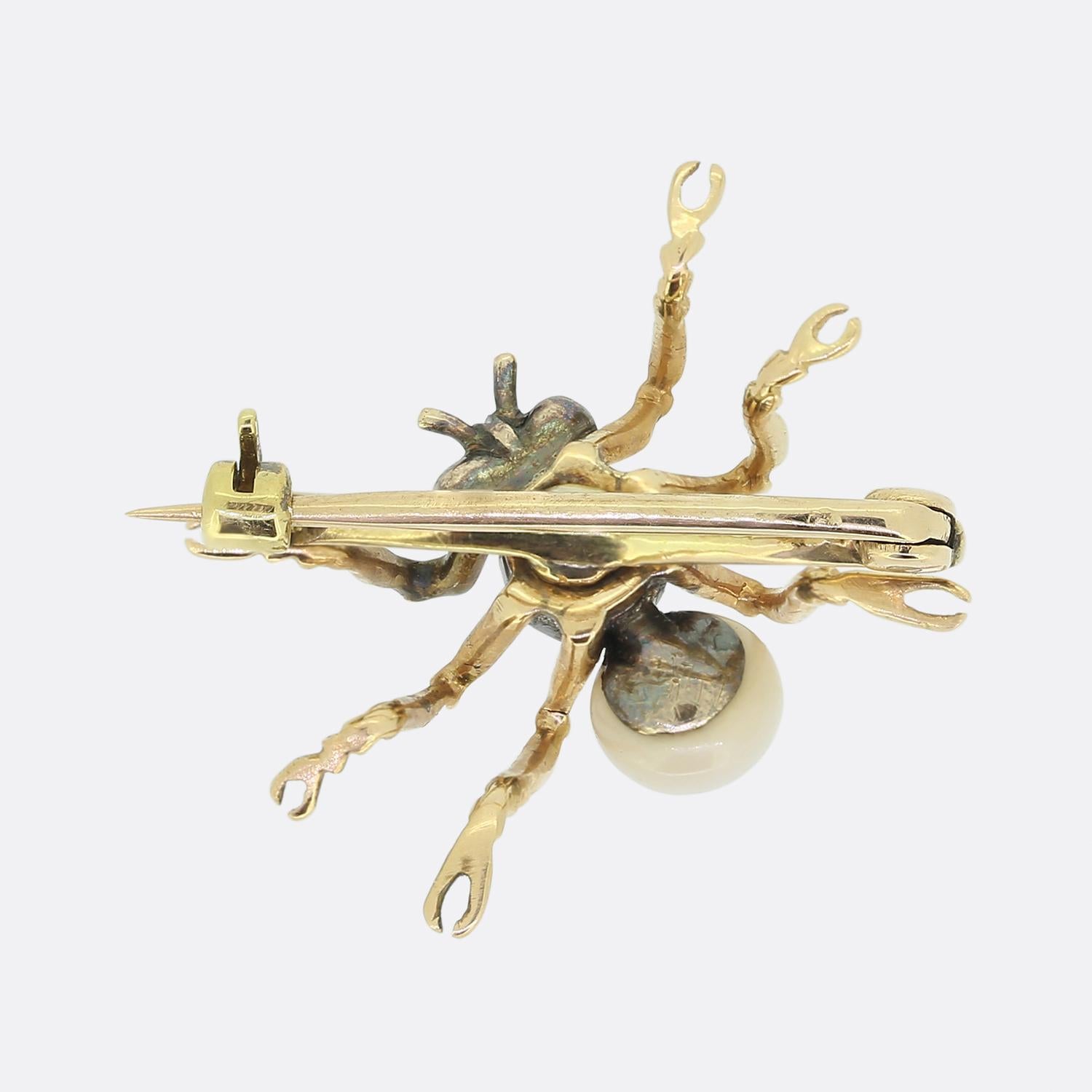Here we have a wonderfully detailed antique brooch crafted into the shape of a six-legged bug. A silver cut-collet set old cushion cut diamond acts as the body with an off-round white pearl sitting just below. These focal gemstones play host to gold
