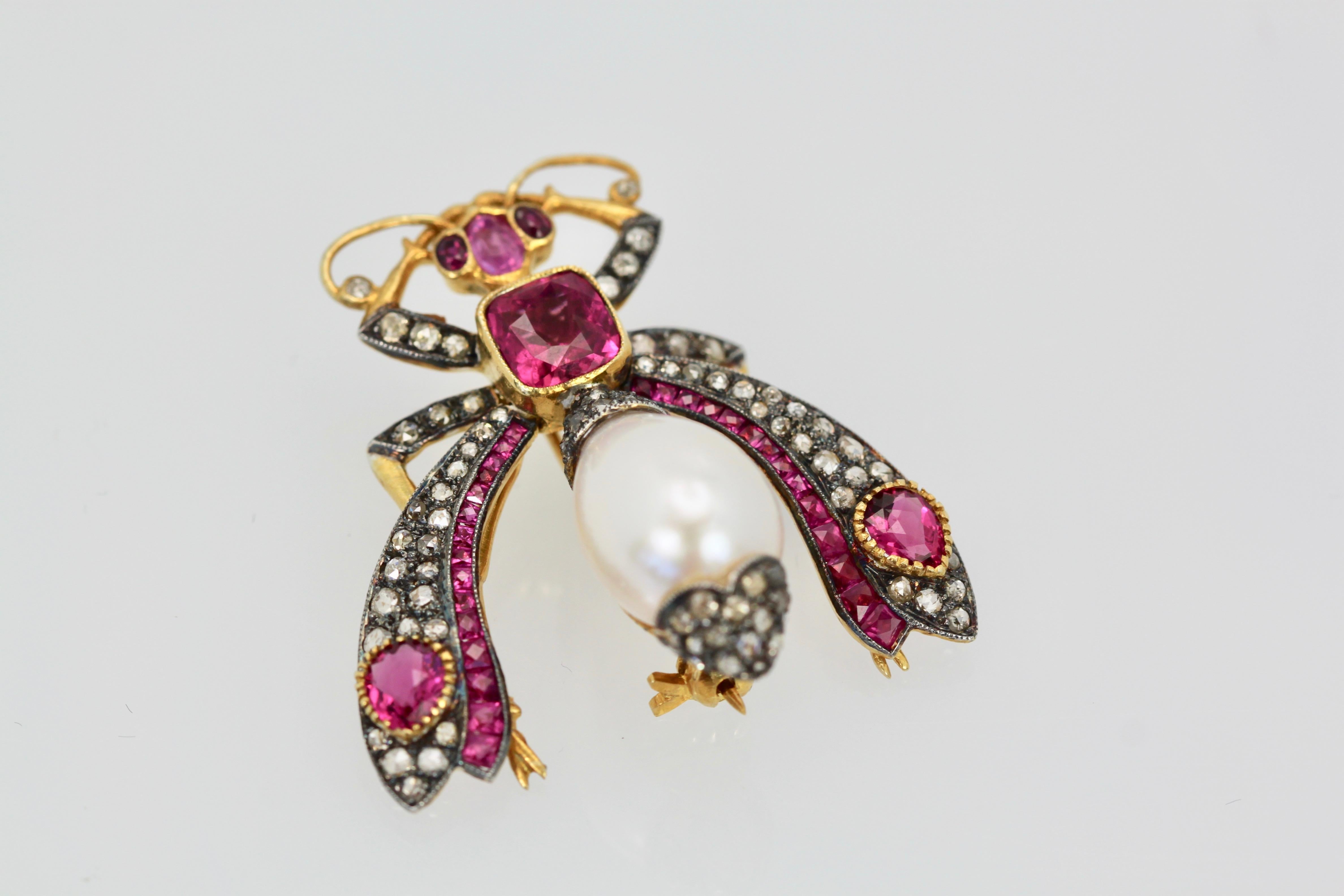 This gorgeous Ruby Pearl Diamond Insect brooch is large and wearable as a pendant or brooch.  The wings are tremblant, Diamonds are on blackened gold.  Center Square Ruby is 1 carat, 2, 1/4 carat pear Rubies and 3 oval Rubies calibrated.  There are