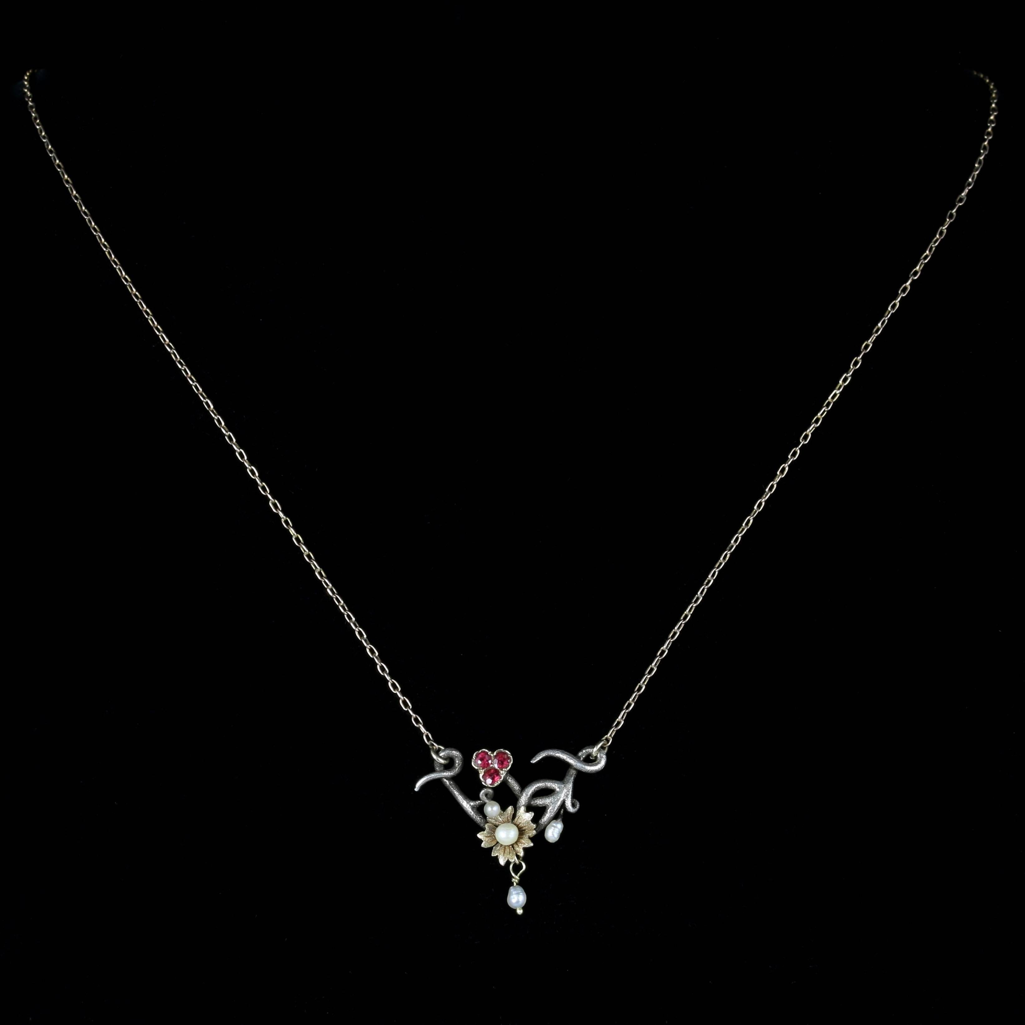 For more details please click continue reading down below...

This beautiful Ruby and Pearl necklace is set in 9ct Yellow Gold and Silver. Circa 1900

Made in the Art Nouveau style.

Lovely rich pink Rubies and lustrous natural Pearls adorn this