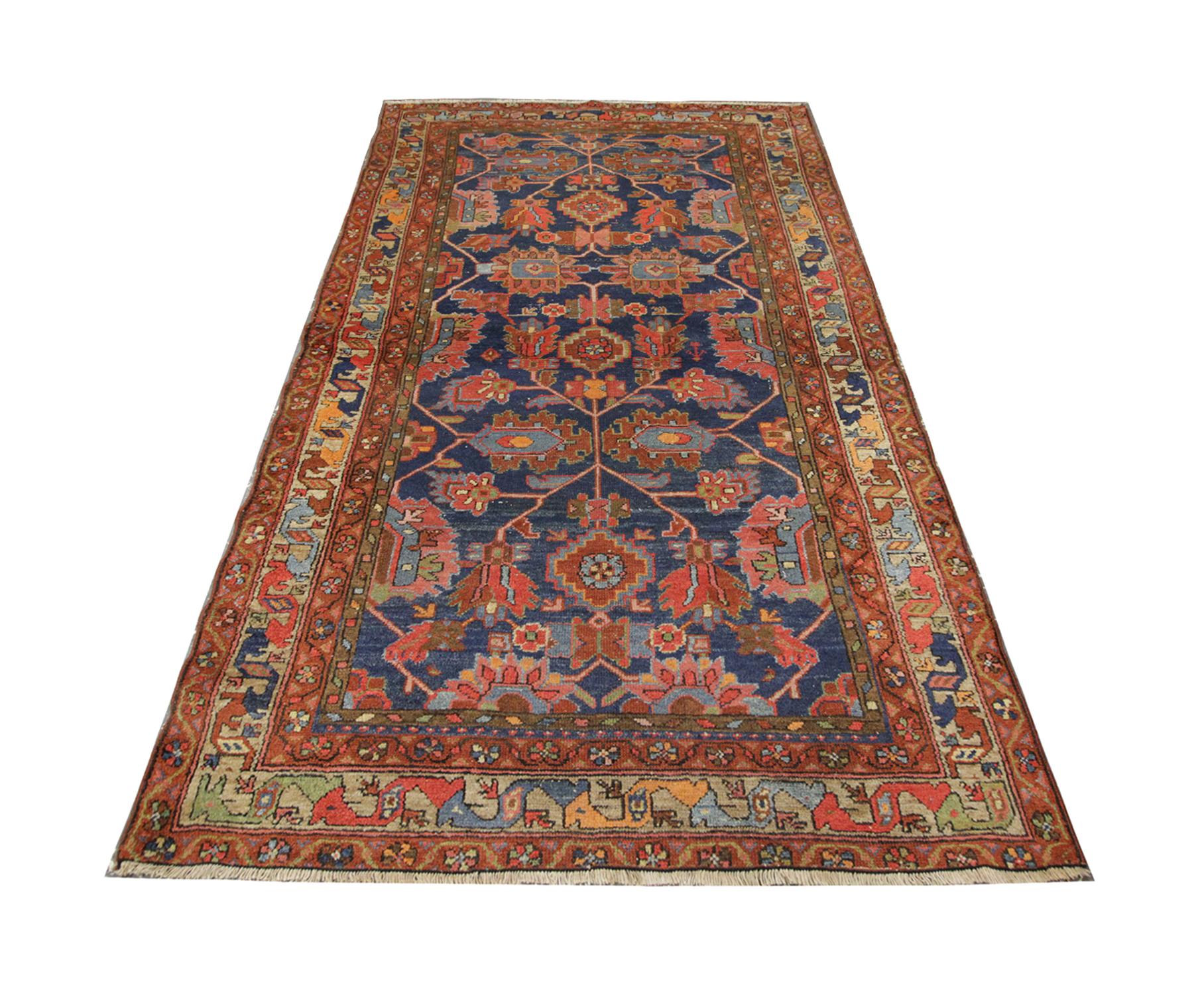 This antique area rug was handwoven by artisans with handspun wool which has been dyed using organic vegetable dyes. The multi-layered border features symbolic details believed to have been an emulation of dragons. In Chinese mythology, they are