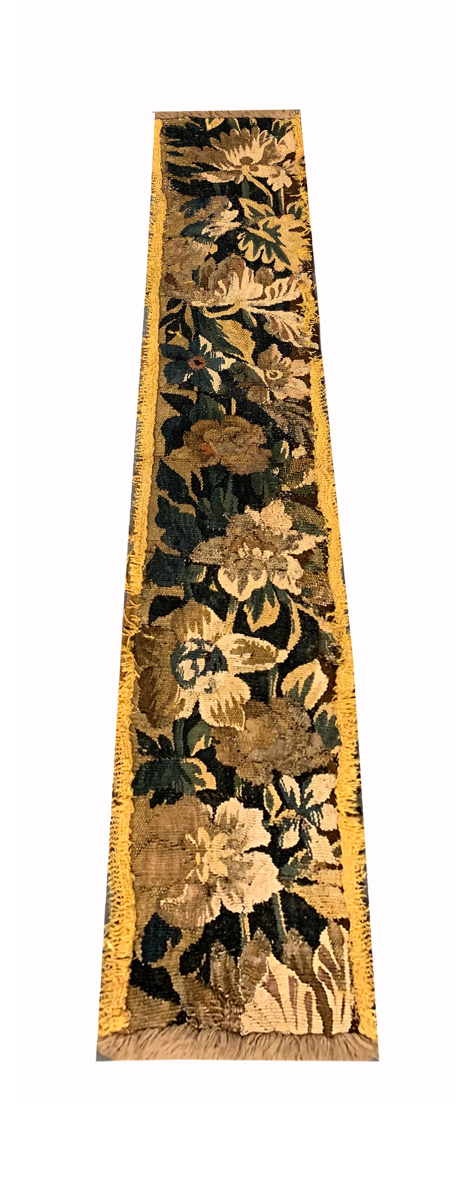 This antique tapestry piece is a Flemish needlepoint woven by hand in the late 19th century, circa 1890. The design features a bold flowing floral pattern woven with elegance and sophistication. Constructed with a subtle yet rich colour palette