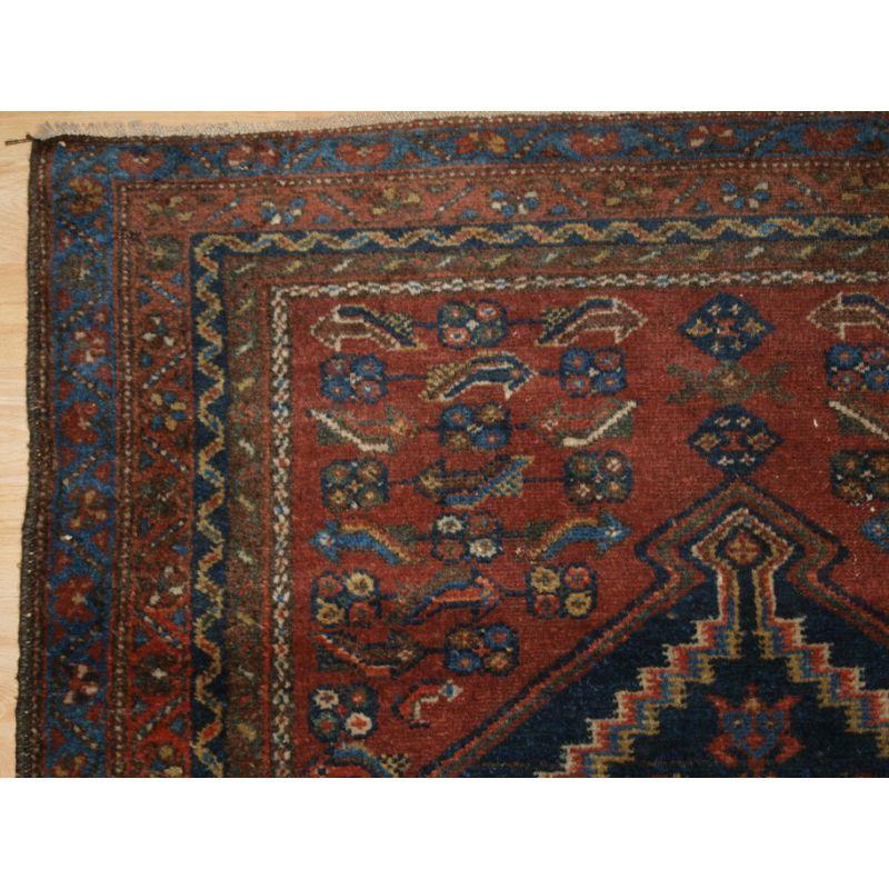 Antique rug from the Greater Hamadan region with a unusual variant of the Heratti design.

The design is most unusual, with the large central medallion and the field containing a very simple version of the well known heratti design.

The colours