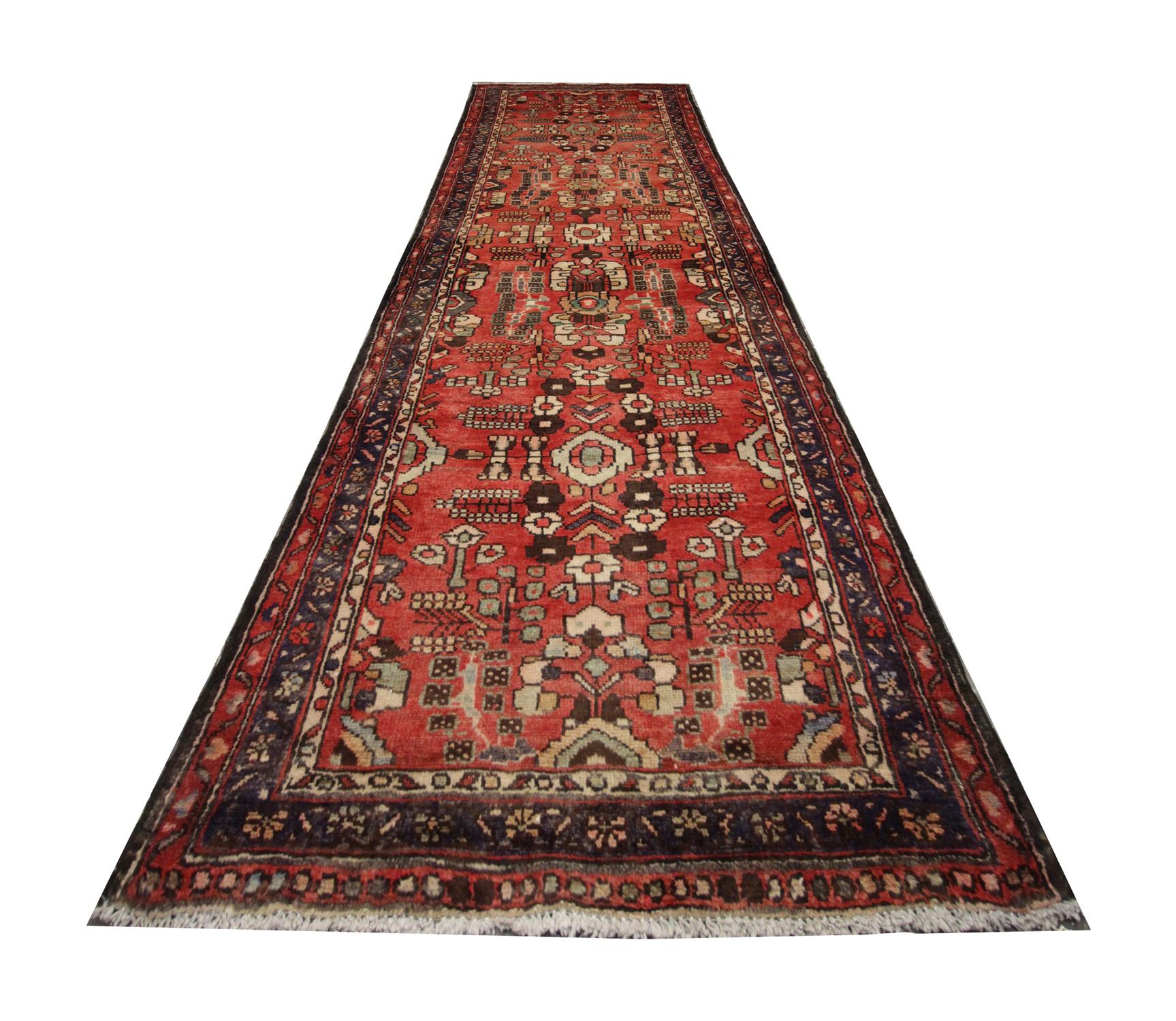 Handmade carpet Oriental rug in and bold yet harmonious colours of brown, red and cream with a geometric central design that features a repeat pattern of intricate shapes in a mixture of muted colours. This antique runner was handwoven in the 1950s