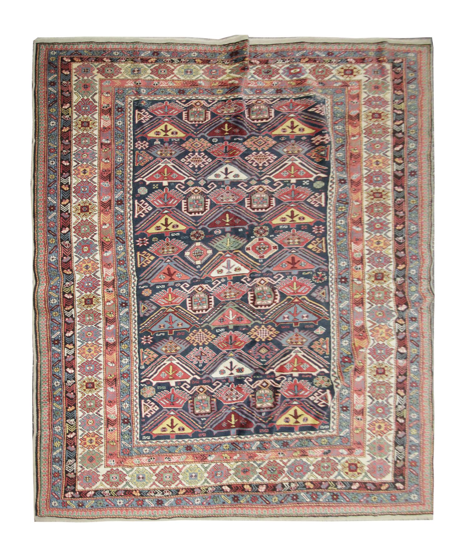 This Oriental rug originates from Shirvan, Azerbaijan; it has been woven by hand with handspun wool and dyed with 100% organic vegetable dyes. With a multi-layered border and a symmetrical pattern, this rug will stand out against any hardwood floor.