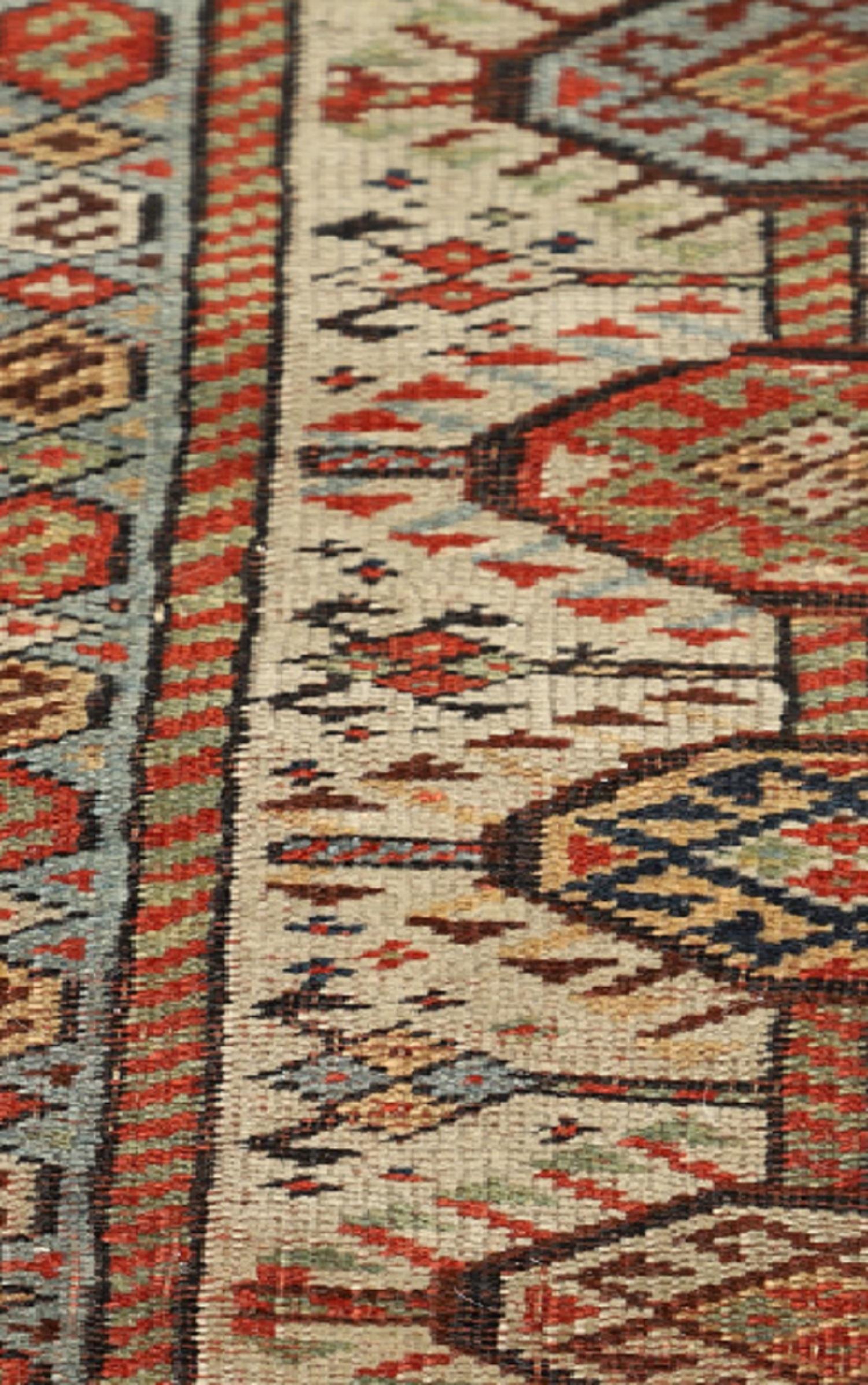 This Oriental rug originates from Azerbaijan; it has been hand-woven with hand-pun wool and dyed with 100% organic vegetable dyes. With a multi-layered border and a symmetrical pattern, this rug will stand out against any hardwood floor. The