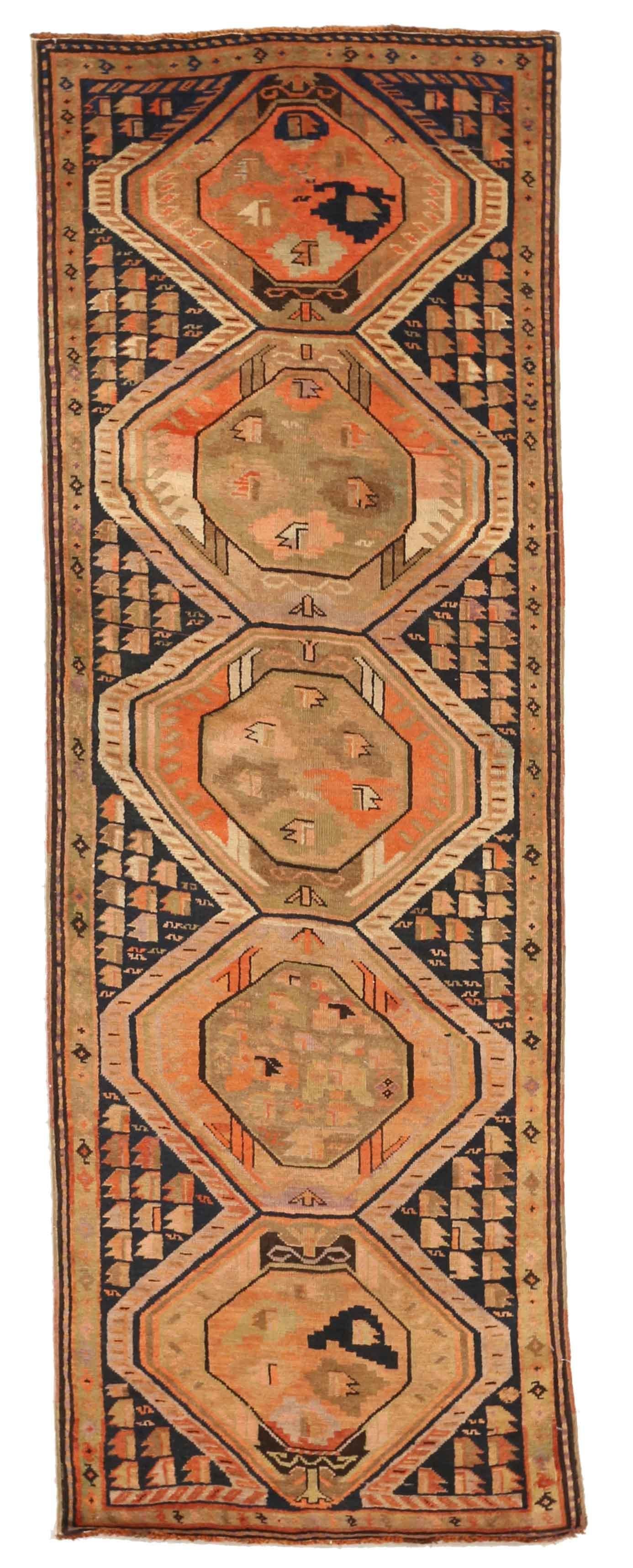 This finely knotted antique rug of Russian origin comes in a distinctive navy blue and coral green color combination. It will blend seamlessly in a minimalist or contemporary themed space.
This gem was crafted in the 1910s using Karabagh style of