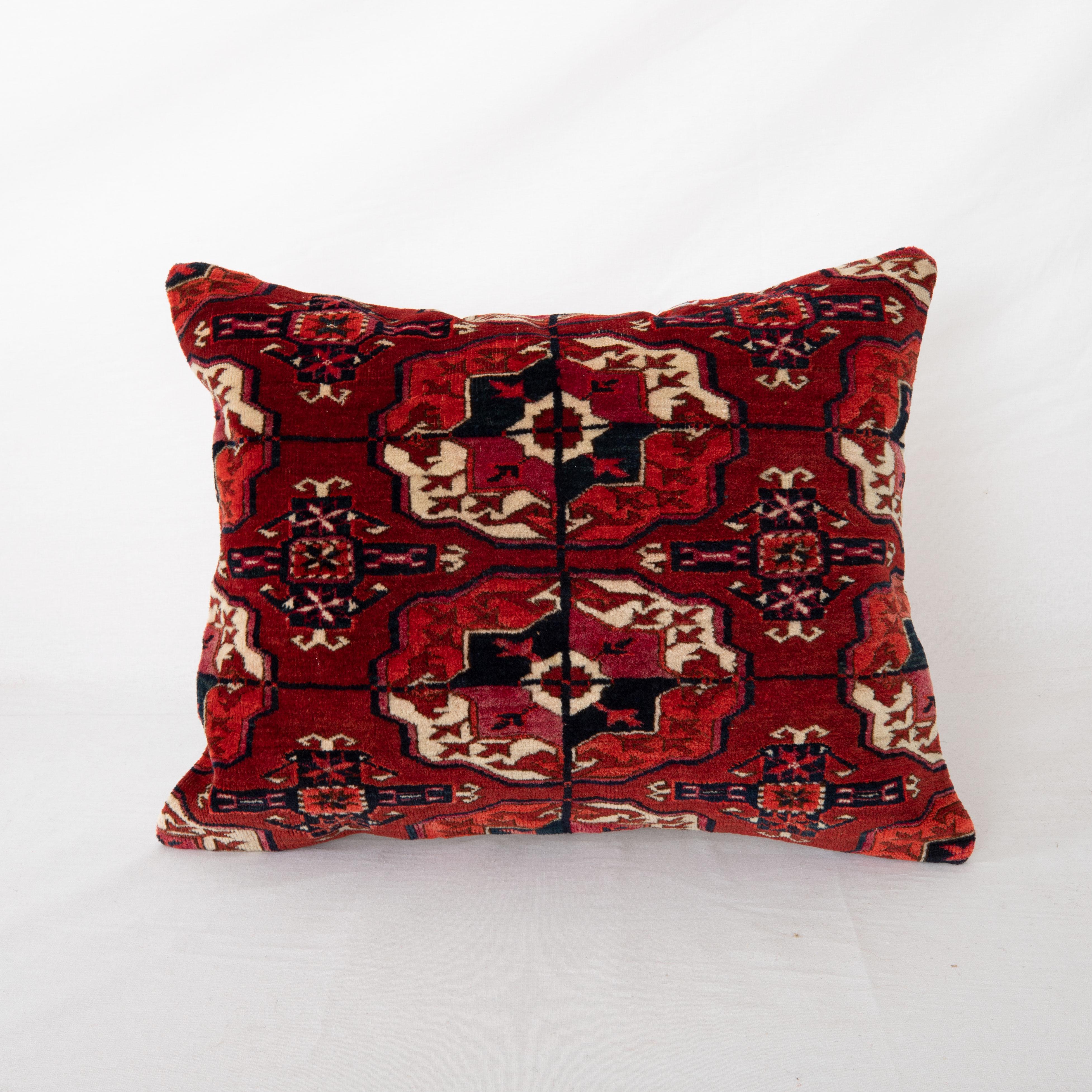 Pillowcase is made from an antique Turkmen, Tekke tribe main rug fragment dating back to 1860s.

It does not come with an insert but a bag made to size to accommodate insert materials.
Linen in the back.
Zipper Closure.
Dry Clean is