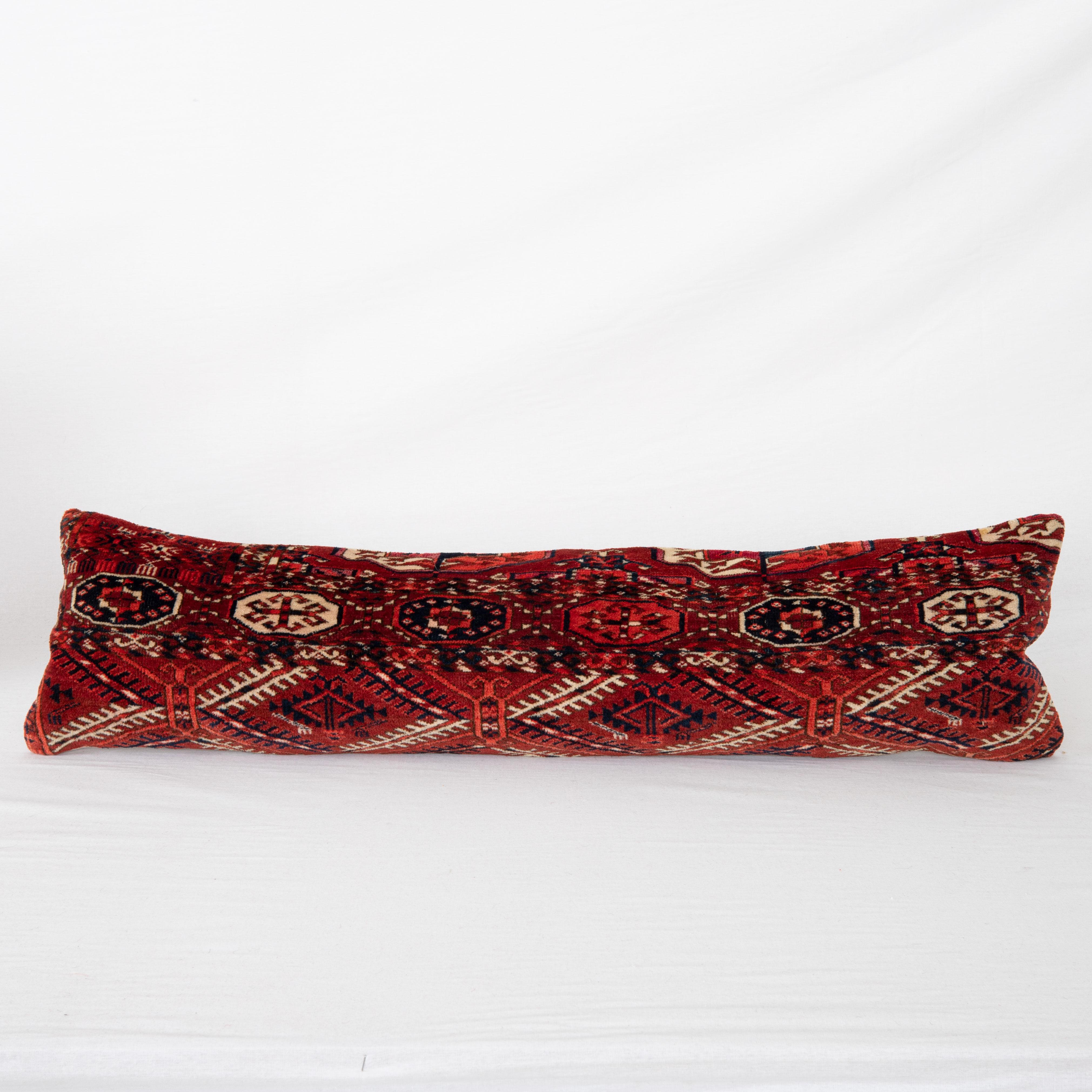 Pillowcase is made from an antique Turkmen, Tekke tribe main rug fragment dating back to 1860s.

It does not come with an insert but a bag made to size to accommodate insert materials.
Linen in the back.
Zipper Closure.
Dry Clean is