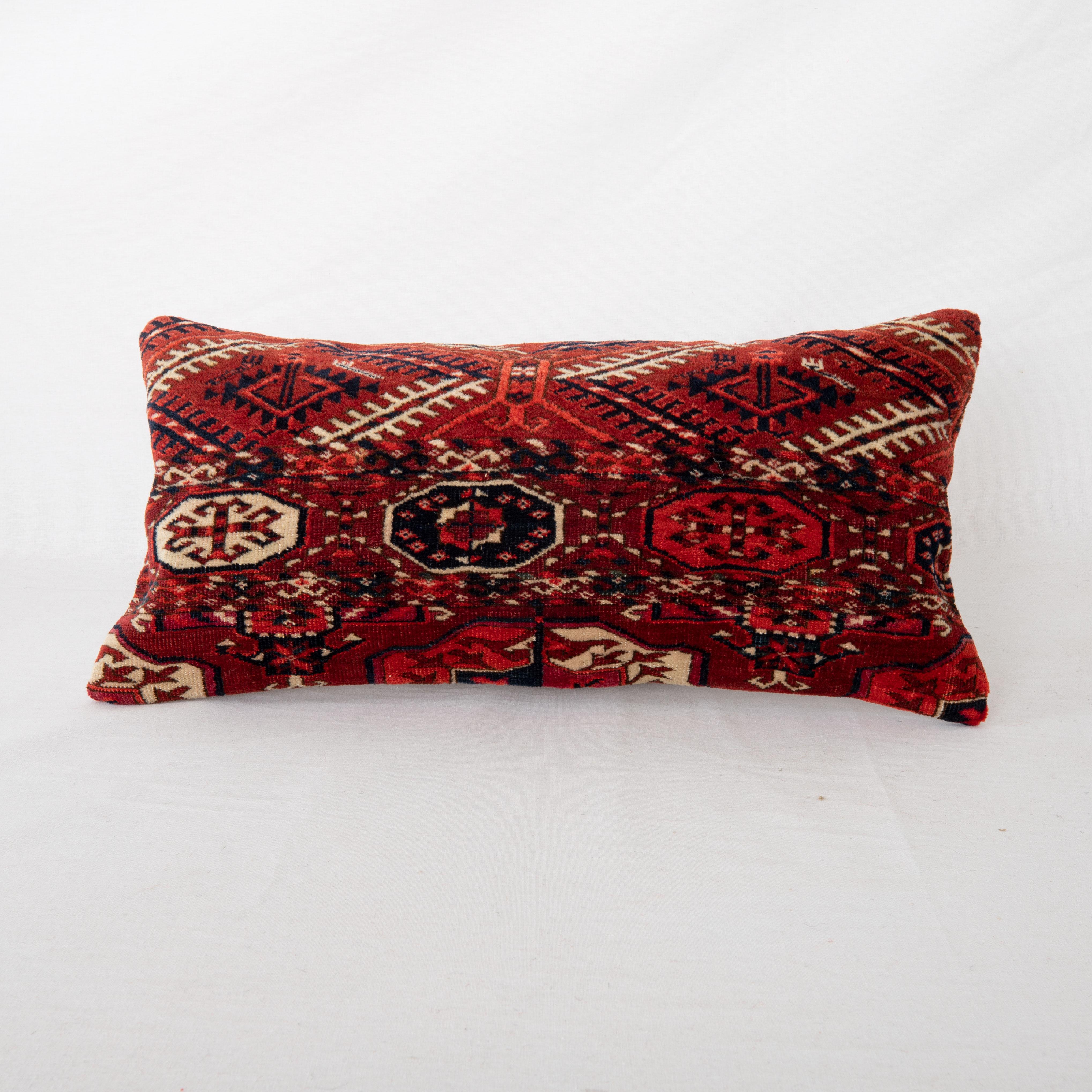 Pillowcase is made from an antique Turkmen, Tekke tribe main rug fragment dating back to 1860s.

It does not come with an insert.
Linen in the back.
Zipper Closure.
Dry Clean is reccommended.