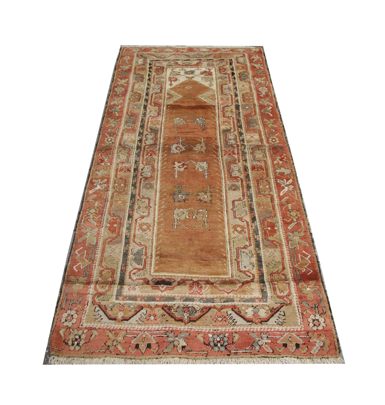 This handmade carpet with deep blue central Asian antique rug was handwoven in Kohtan in 1989. Three circular emblems flow through the centre in red and peach, surrounded by geometric flower motifs. Enclosed by patterned corner designs and a layered