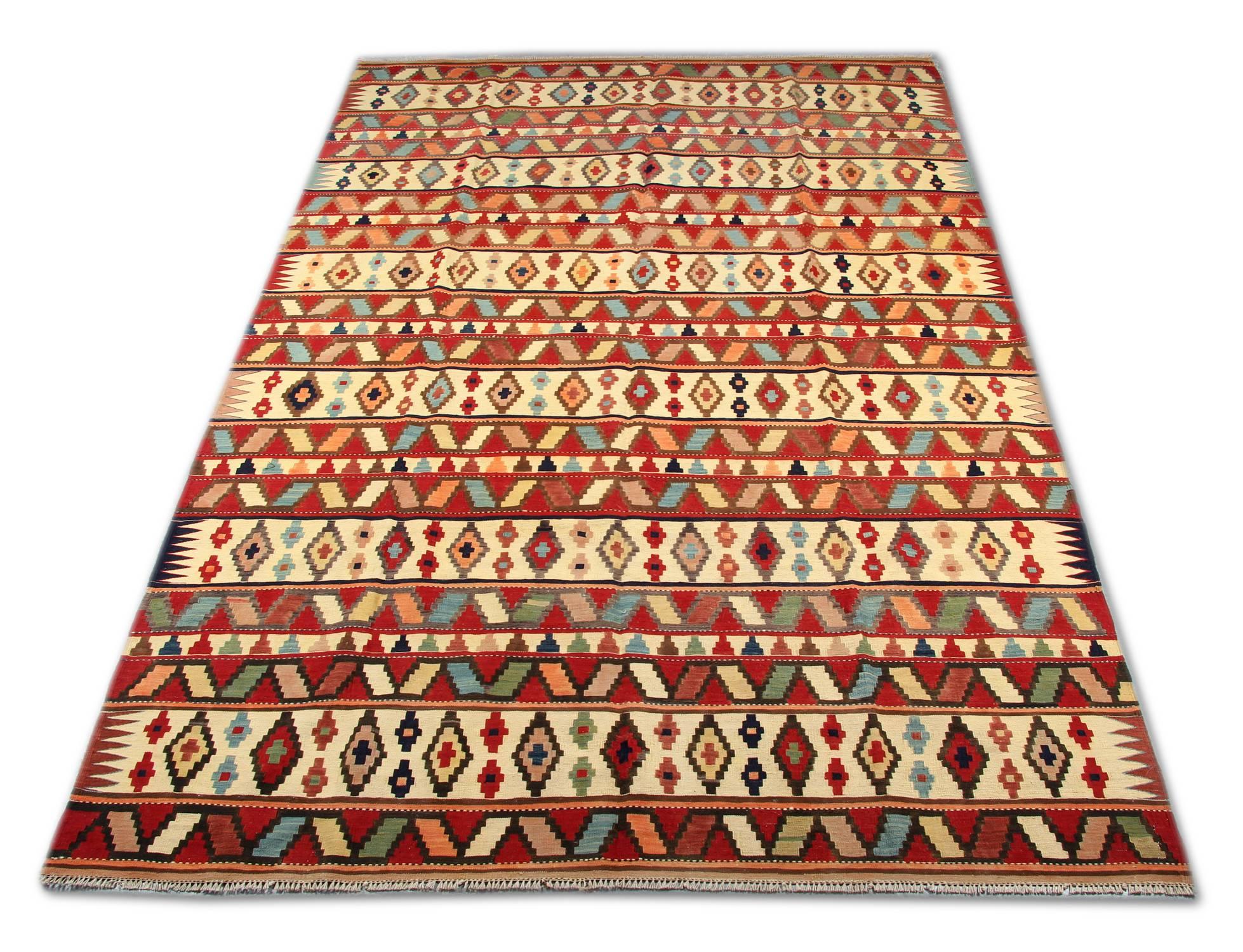 This handmade carpet colourful Caucasian carpet oriental rug is woven by very skilled weavers in Azerbaijan, who used the highest quality wool and cotton. The flat-weave rug has ivory, orange Salmon, green, white, pink, black and brown colours. The