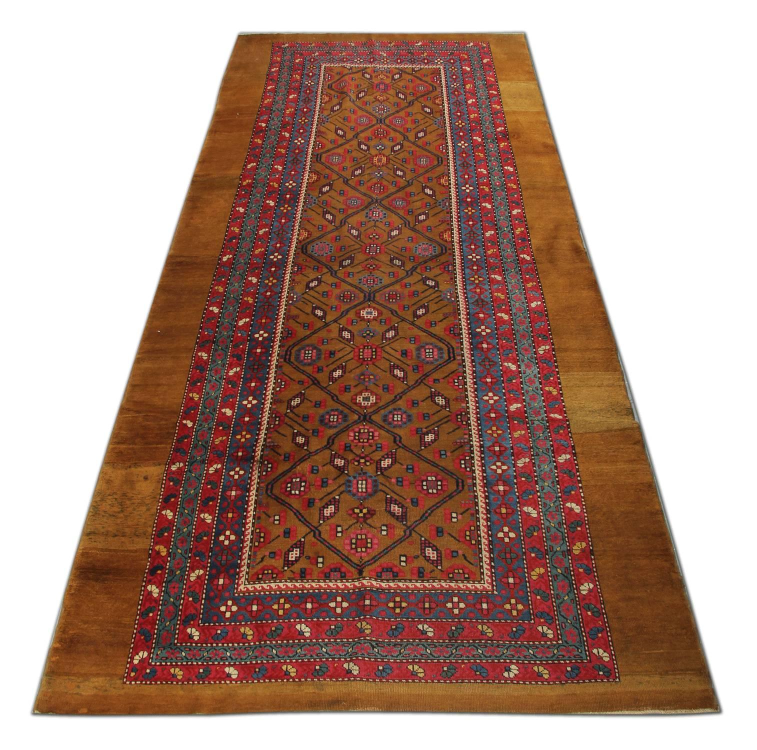 These handmade carpet runner oriental rugs are a rare find because of their colour combination. This is a beautiful old camel ground woven rug in near-mint condition. Antique rugs are made with a full pile everywhere, finely woven and full of charm.
