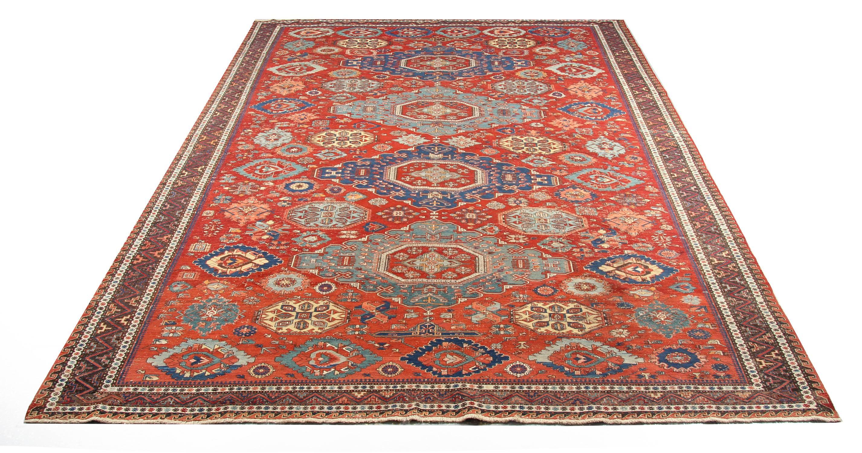 Handmade carpet Kuba Soumakh is often decorated with large abstract intended medallions arranged in a well-organized format, and this composition appears from the number of such oriental rugs to have been popular with the weavers. This is an antique