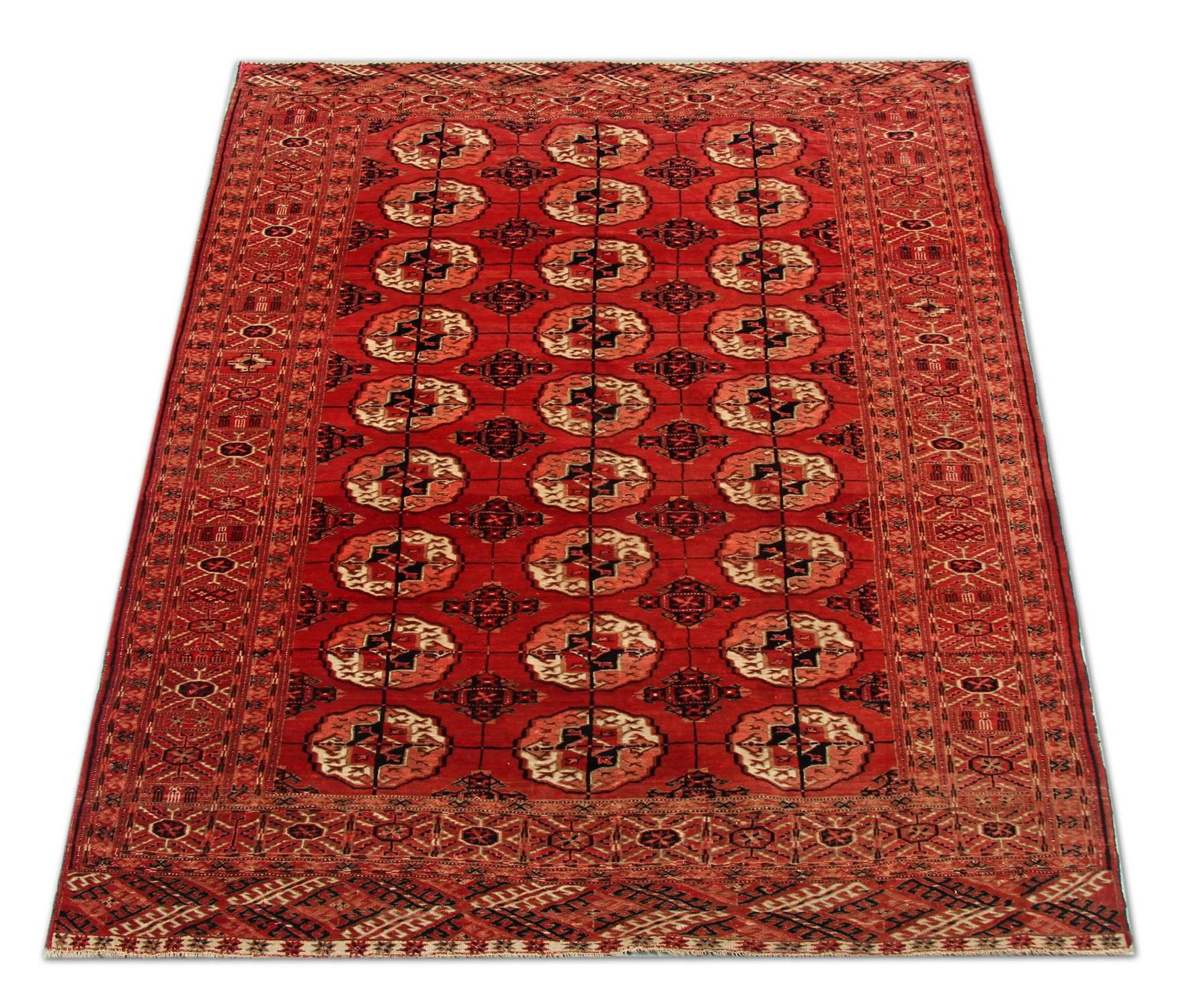 This is an example of fine Afghan red rug made by highly skilled Turkmen handmade rugs weavers in the north of Afghanistan. They have used hand-spun wool and 100% organic dyes for the production of these wool rugs. This tribal rug has repeating