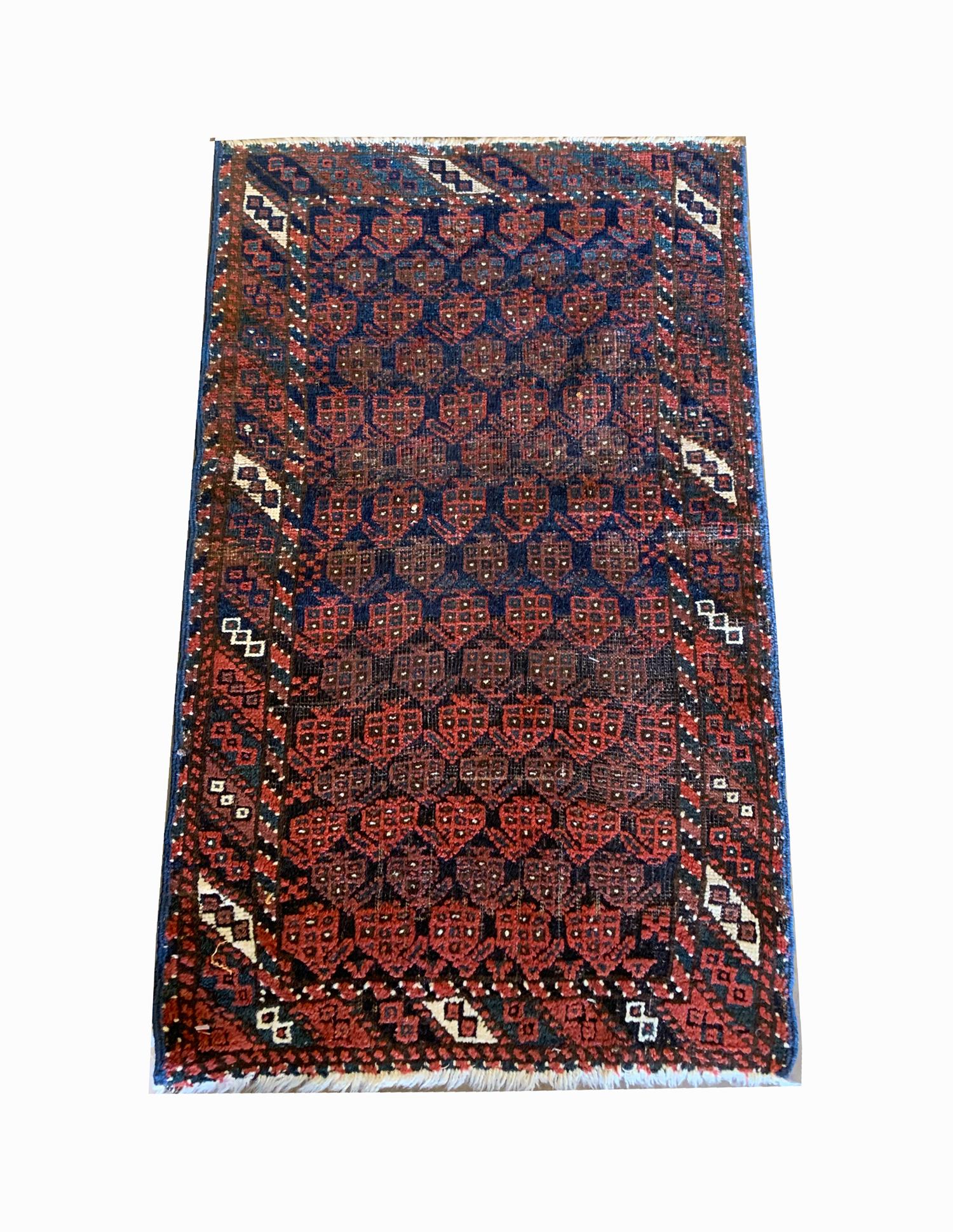 This fine wool rug was woven by hand in Afghanistan country in the Caucasus region known for there bold designs. The central design features a repeat tribal motif pattern woven in red on deep blue background. A layered geometric border has then