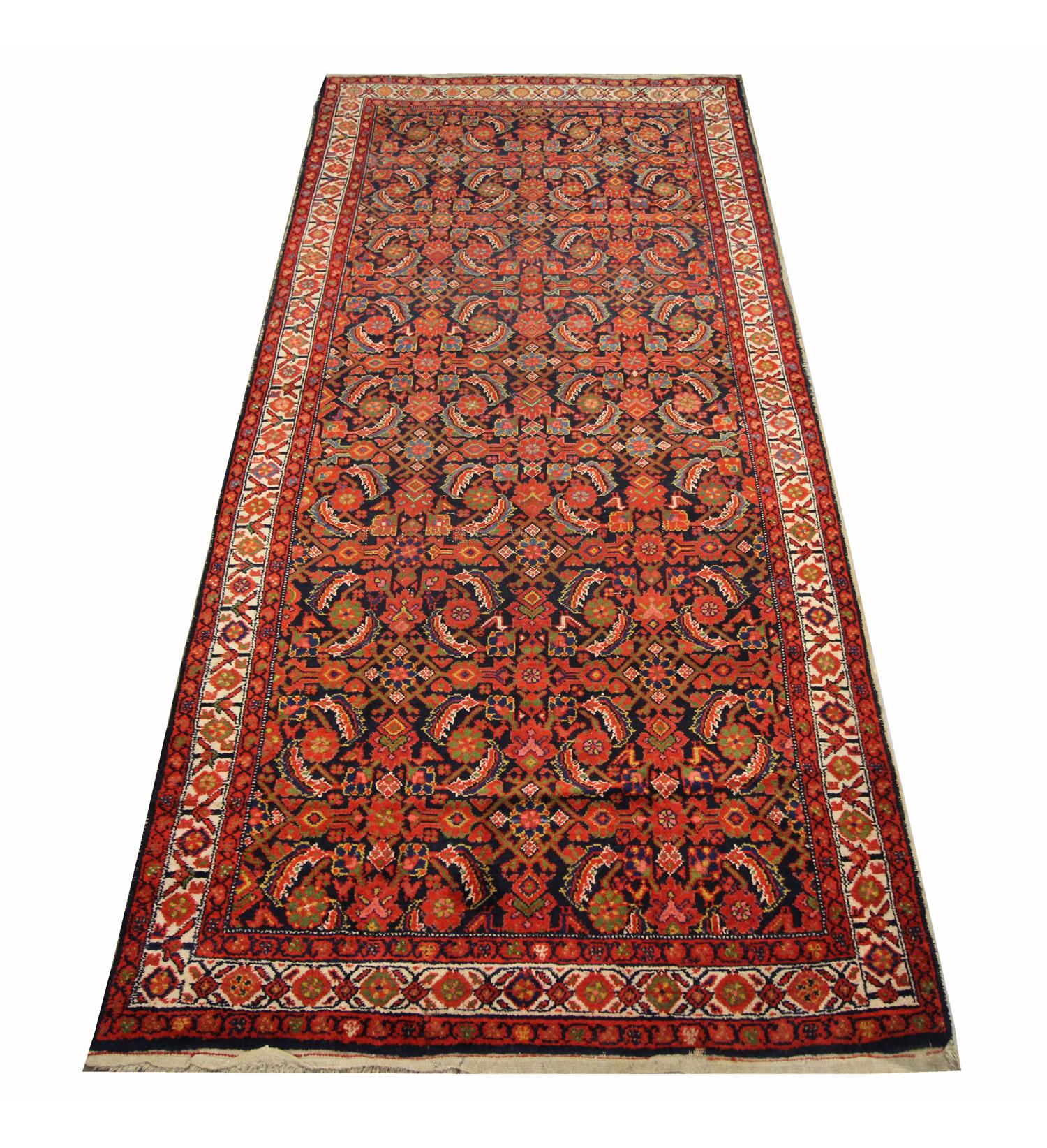 This fine hand woven wool area rug was woven in Azerbaijan in the 1880s. The central design has been woven with a rich colour palette, including rust, blue, ivory and red that make up the symmetrical floral design. Both the colour and patterns in